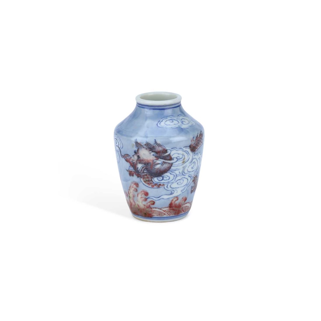 A CHINESE PORCELAIN JARLET: A CHINESE PORCELAIN JARLET of tapering baluster form, decorated in underglaze blue and iron-red enamels with dragons amongst scrolling clouds above crashing waves, bears an underglaze blue six-charact