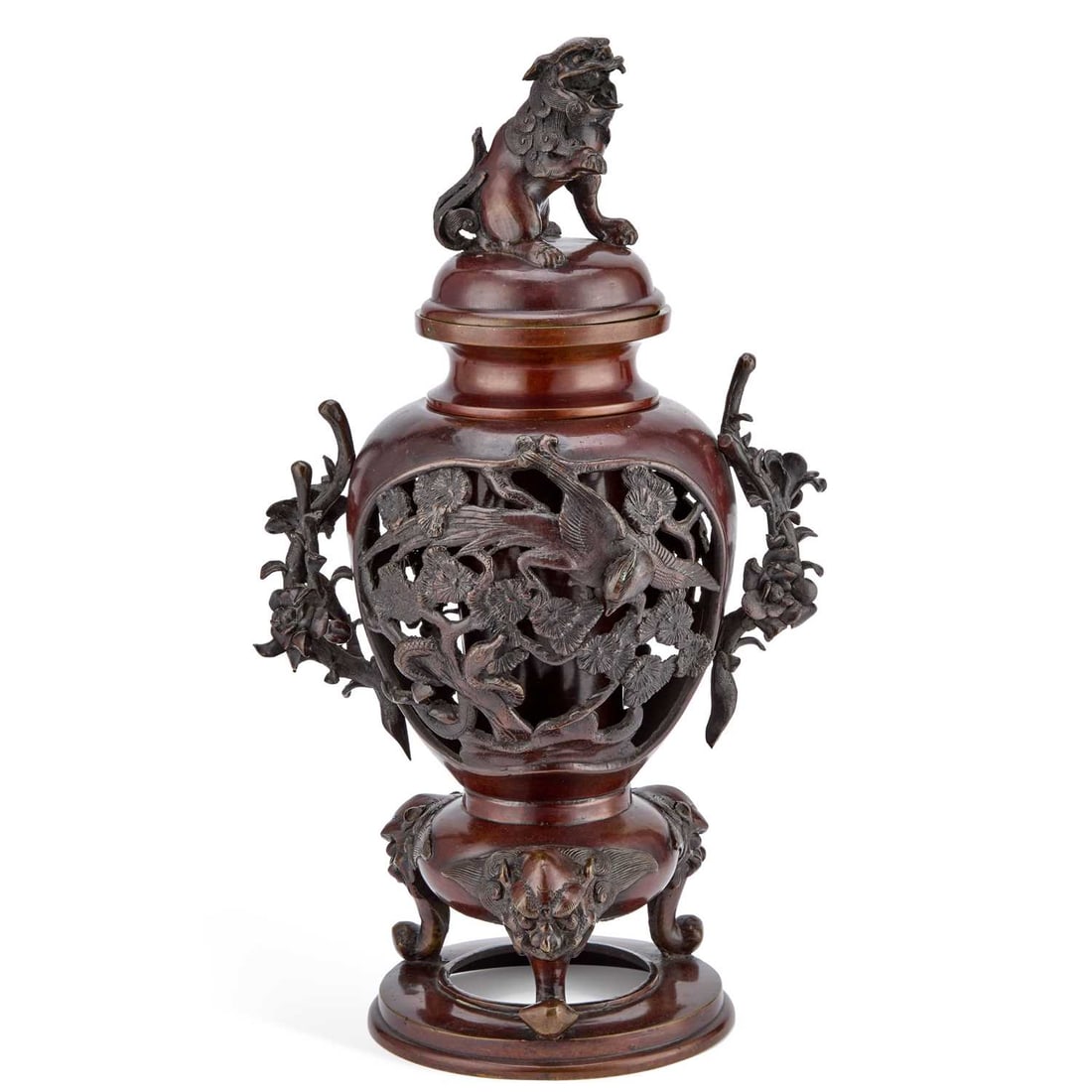A JAPANESE BRONZE KORO AND COVER MEIJI PERIOD (1868-1912): A JAPANESE BRONZE KORO AND COVER MEIJI PERIOD (1868-1912) decorated with pierced panels of birds amongst flowering plants, having foliate handles, set upon three shishi dog headed feet, the cover