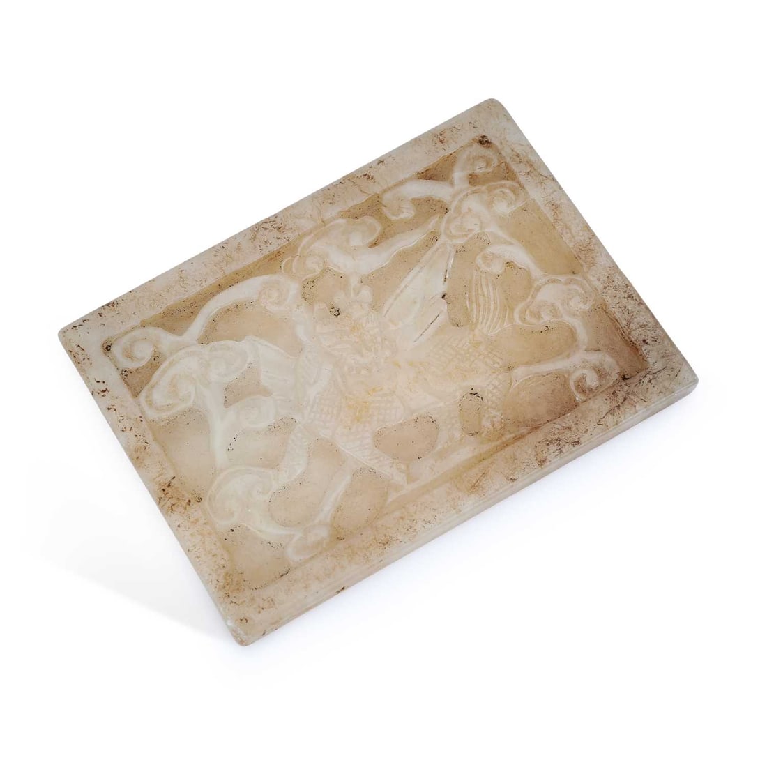 A CHINESE JADE RECTANGULAR PLAQUE: A CHINESE JADE RECTANGULAR PLAQUE carved in relief with a qilin amidst scrolling clouds within a recessed border, the pale stone with russet and dark inclusions. 11cm by 8cm