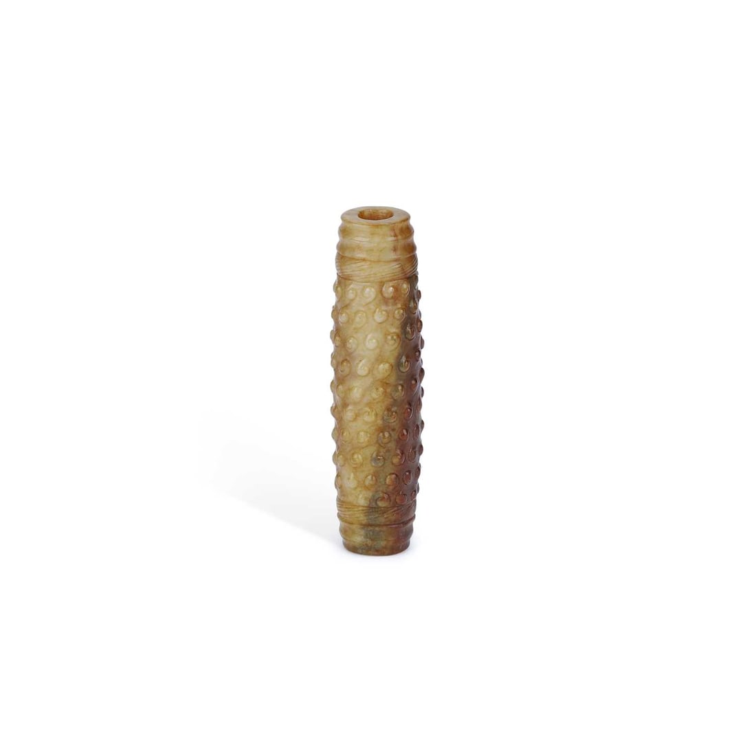 A CHINESE JADE PENDANT: A CHINESE JADE PENDANT of tubular form, the mottled russet and celadon stone carved in relief with dense raised bosses between concentric ring borders. 9cm long