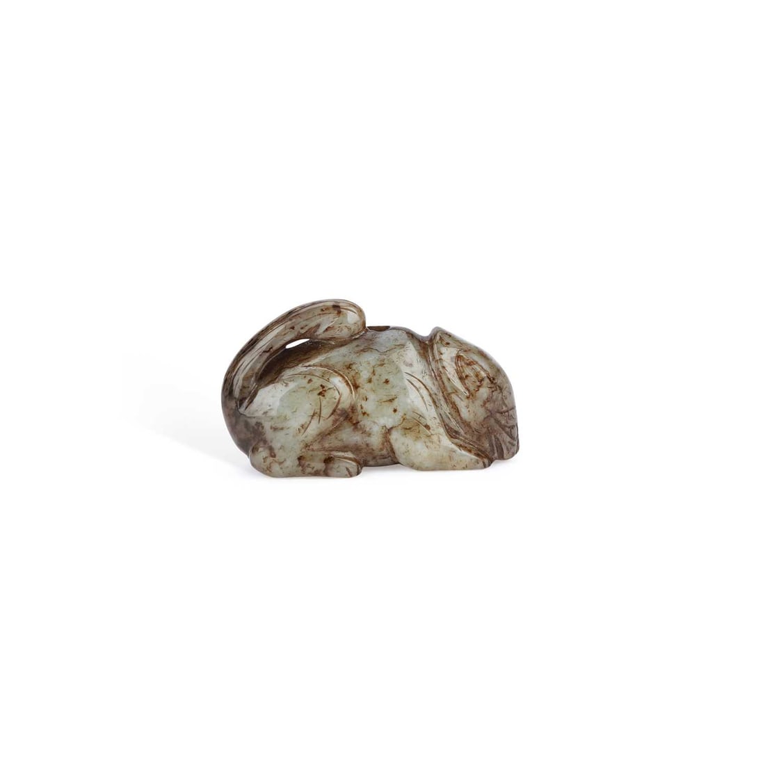 A CHINESE MOTTLED GREY JADE MODEL OF A SQUIRREL: A CHINESE MOTTLED GREY JADE MODEL OF A SQUIRREL carved recumbent with fore-paws tucked beneath the body and tail curled along the back, the stone with dark russet and black inclusions, drilled for sus