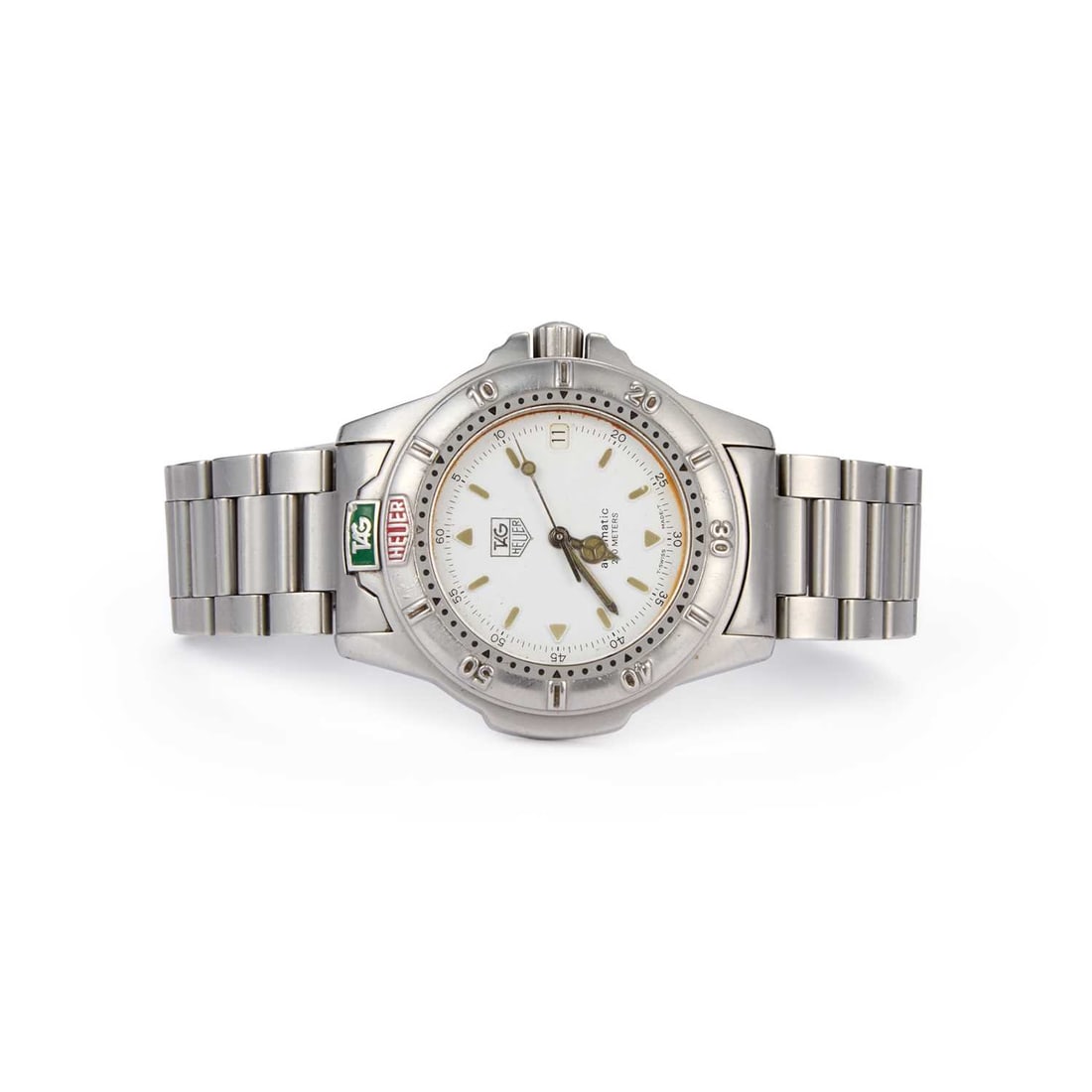 A GENTS STEEL TAG HEUER 4000 AUTOMATIC BRACELET WATCH: A GENTS STEEL TAG HEUER 4000 AUTOMATIC BRACELET WATCH the circular white dial signed TAG Heuer Automatic 200 Meters, with luminous baton and arrow indices and luminous hands, outer minute markers with
