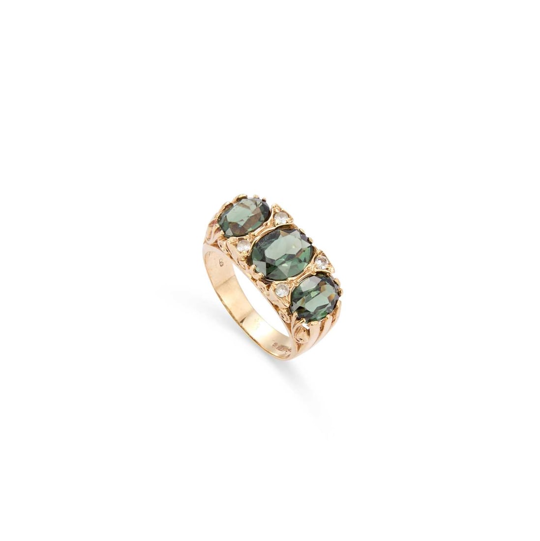 A 9CT YELLOW GOLD GREEN GARNET THREE STONE RING: A 9CT YELLOW GOLD GREEN GARNET THREE STONE RING in the Victorian style, sponsor's mark 'RJ', London 1973, set with three oval mixed cut green garnet and four colourless stones. Ring size P, 5.2 grams 