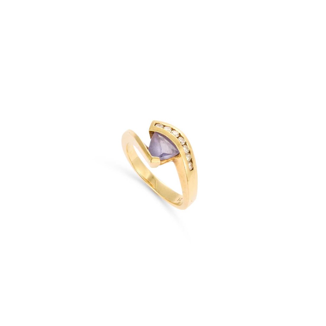 A TANZANITE AND DIAMOND RING: A TANZANITE AND DIAMOND RING a trilliant-cut tanzanite to channel-set diamond scroll shoulders, stamped '18K'. Estimated total diamond weight 0.15 carat, ring size N, 6.2 grams Good condition
