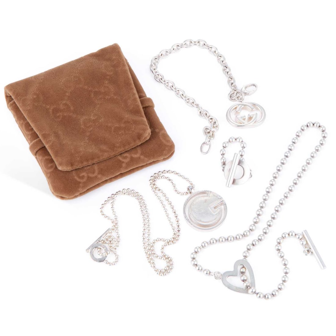 A GROUP OF SILVER GUCCI JEWELLERY: A GROUP OF SILVER GUCCI JEWELLERY comprising a ball link chain static toggle ring, Italian hallmarks; a G pendant on a ball link chain necklace with a toggle clasp, Italian hallmarks; a GG chain link 