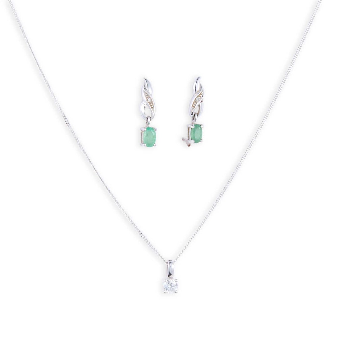 A 9 CARAT WHITE GOLD SOLITAIRE DIAMOND PENDANT ON CHAIN AND A PAIR OF EMERALD AND DIAMOND EARRINGS: A 9 CARAT WHITE GOLD SOLITAIRE DIAMOND PENDANT ON CHAIN AND A PAIR OF EMERALD AND DIAMOND EARRINGS comprising the pendant featuring a round brilliant-cut diamond in a claw setting, to a fine chain