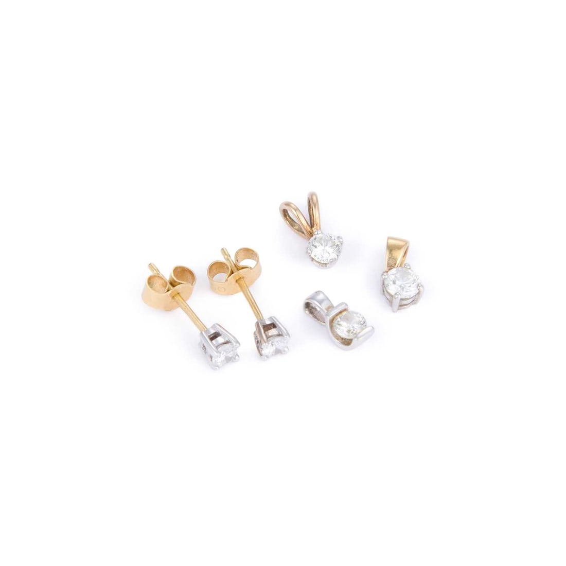 A PAIR OF 18 CARAT GOLD SOLITAIRE DIAMOND EARRINGS AND THREE 9 CARAT GOLD SOLITAIRE DIAMOND PENDANTS: A PAIR OF 18 CARAT GOLD SOLITAIRE DIAMOND EARRINGS AND THREE 9 CARAT GOLD SOLITAIRE DIAMOND PENDANTS comprising the earrings with post fittings, all hallmarked. (4) Earrings estimated total diamond we