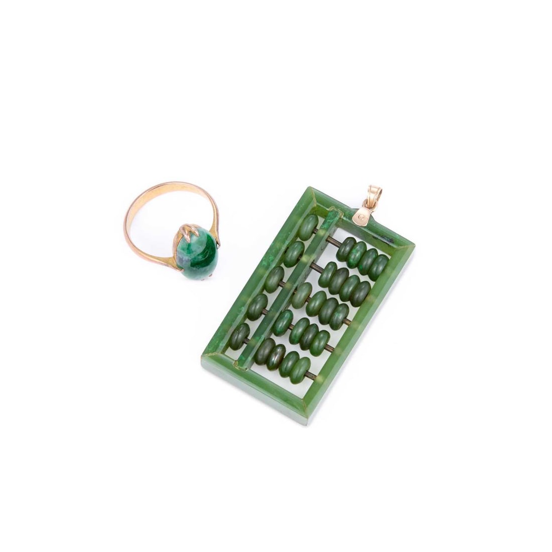 A NEPHRITE RING AND A NEPHRITE ABACUS PENDANT: A NEPHRITE RING AND A NEPHRITE ABACUS PENDANT comprising an oval-cut nephrite in a double claw setting, unmarked; the abacus pendant stamped '18K'. (2) Ring size M1/2, pendant 5cm long, 17.1 grams