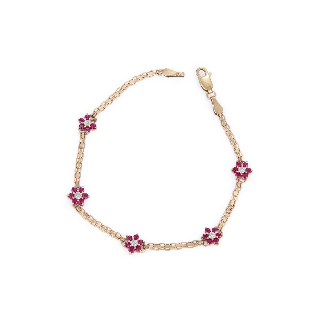 A 9 CARAT GOLD RUBY AND DIAMOND CLUSTER BRACELET: A 9 CARAT GOLD RUBY AND DIAMOND CLUSTER BRACELET round-cut diamond accents within clusters of round-cut rubies, spaced by lengths of fancy links, hallmarked Birmingham 2003. 18.2cm long, 2.8 grams Goo