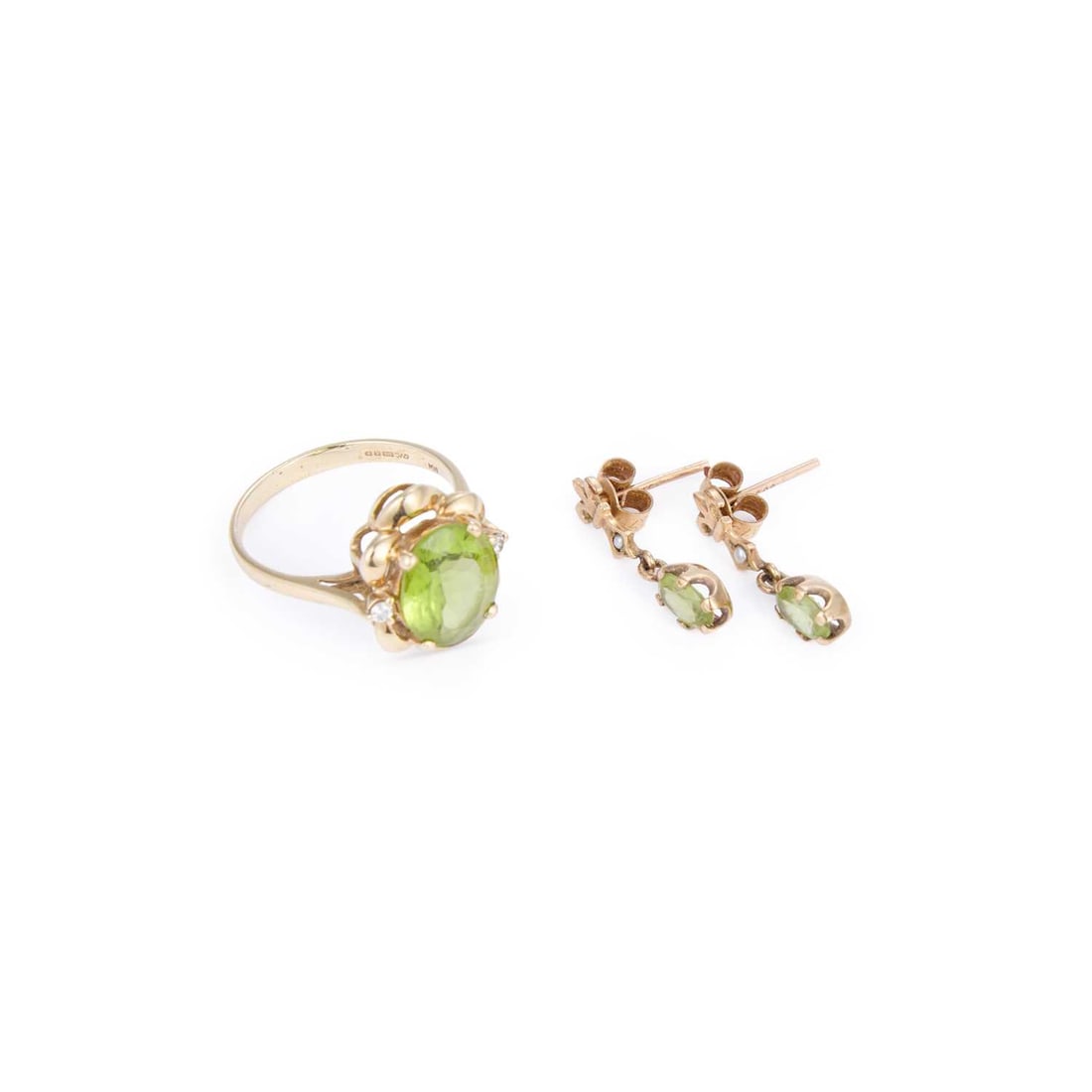 A 9 CARAT GOLD PERIDOT AND DIAMOND RING AND A PAIR OF PERIDOT PENDANT EARRINGS: A 9 CARAT GOLD PERIDOT AND DIAMOND RING AND A PAIR OF PERIDOT PENDANT EARRINGS comprising the ring featuring an oval-cut peridot spaced by round-cut diamonds and within a scroll frame; the earrings