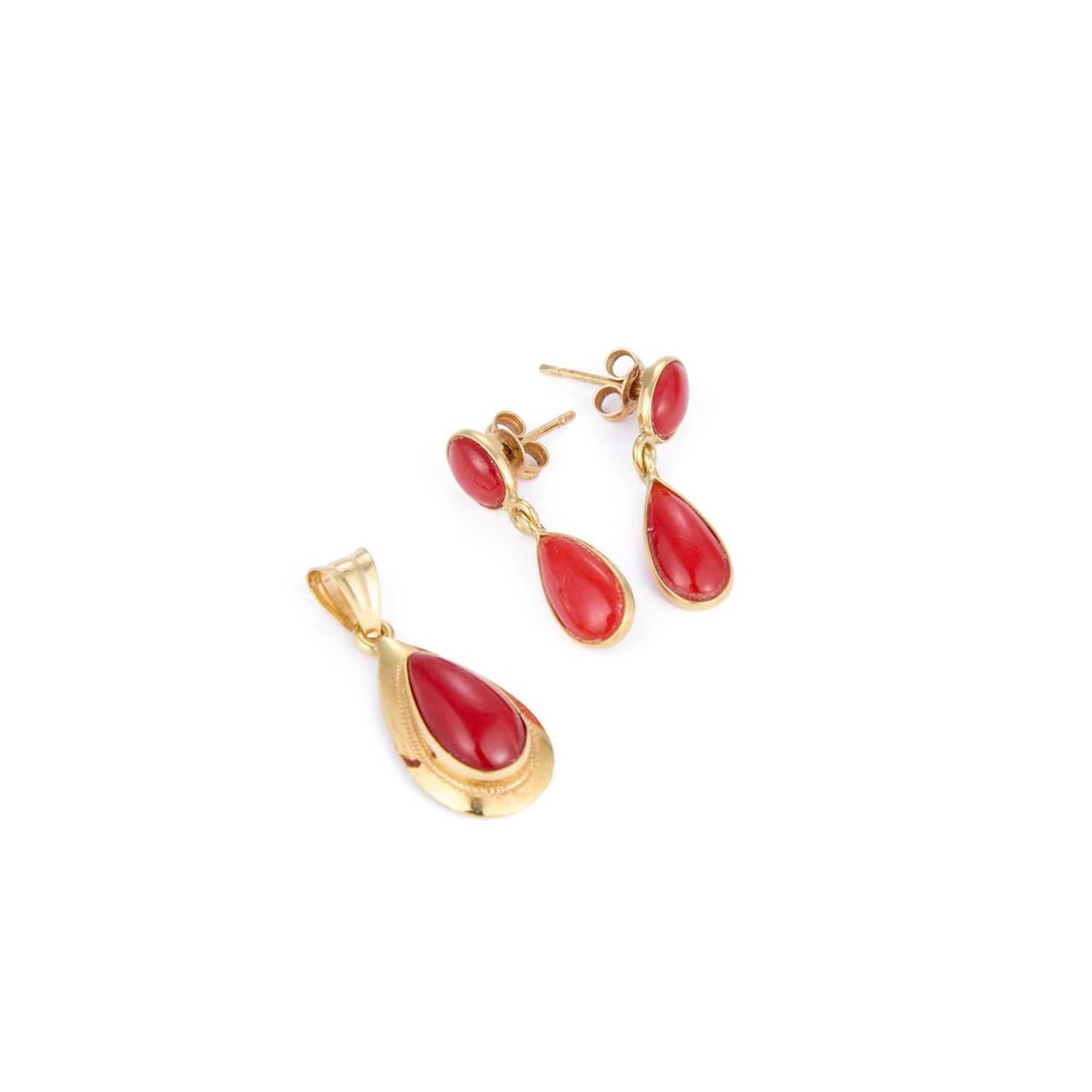 A CORAL PENDANT AND A PAIR OF CORAL PENDANT EARRINGS: A CORAL PENDANT AND A PAIR OF CORAL PENDANT EARRINGS comprising the pendant featuring a pear-cut coral within a plain frame; the earrings featuring pear-cut coral drops to oval-cut coral studs, with