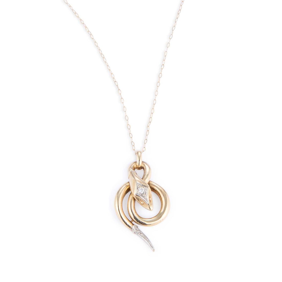 A 9 CARAT GOLD SNAKE PENDANT ON CHAIN: A 9 CARAT GOLD SNAKE PENDANT ON CHAIN a coiled snake with a white stone inset head, to a fine chain, hallmarked import London 1988. Pendant 3.5cm, chain length 41.5cm long, 4 grams Good condition