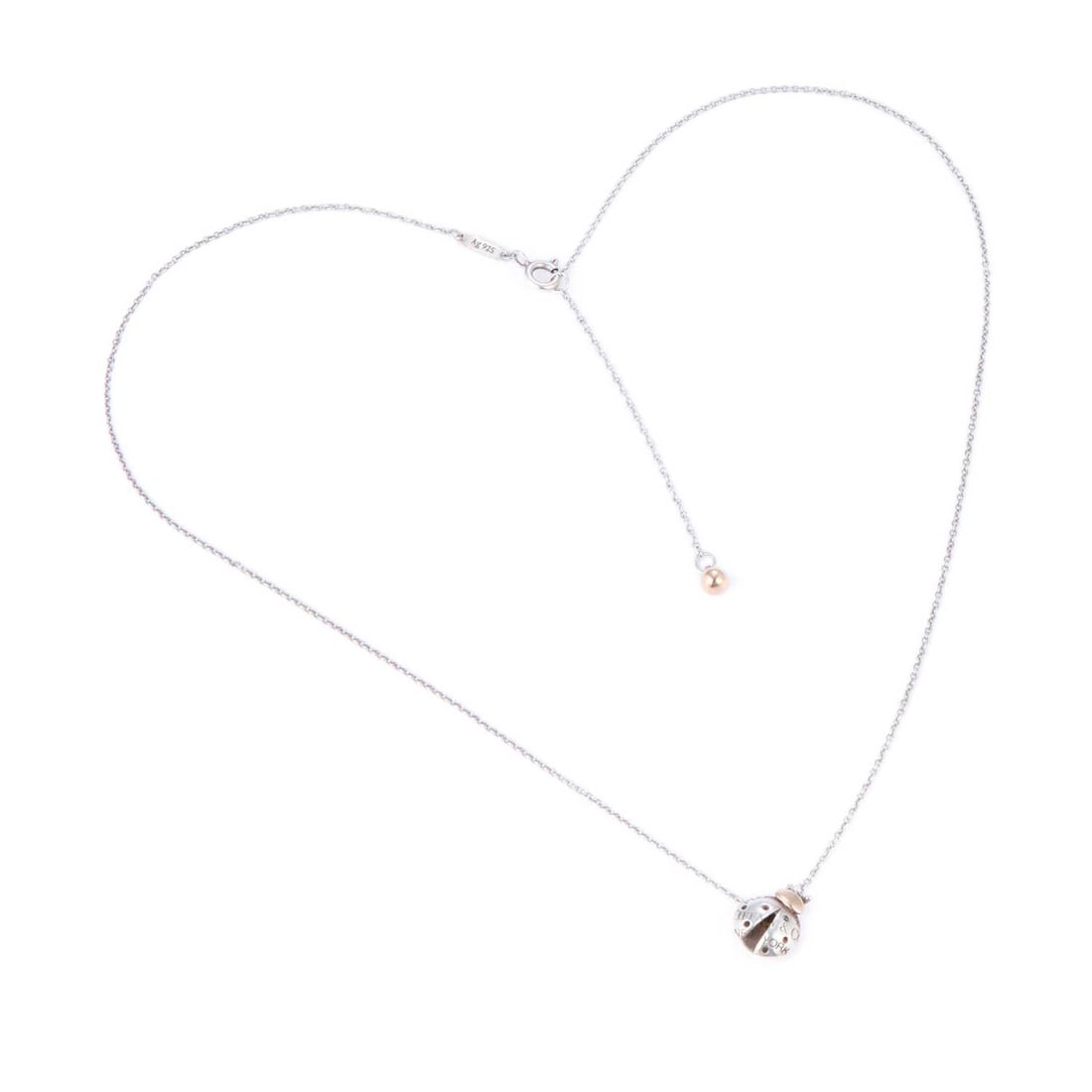 A TIFFANY & CO LADYBUG PENDANT NECKLACE: A TIFFANY & CO LADYBUG PENDANT NECKLACE the static ladybird bi-colour pendant with 'Please Return to Tiffany & Co New York' across its back, on a fine cable link chain, stamped to the back 'Ag 925