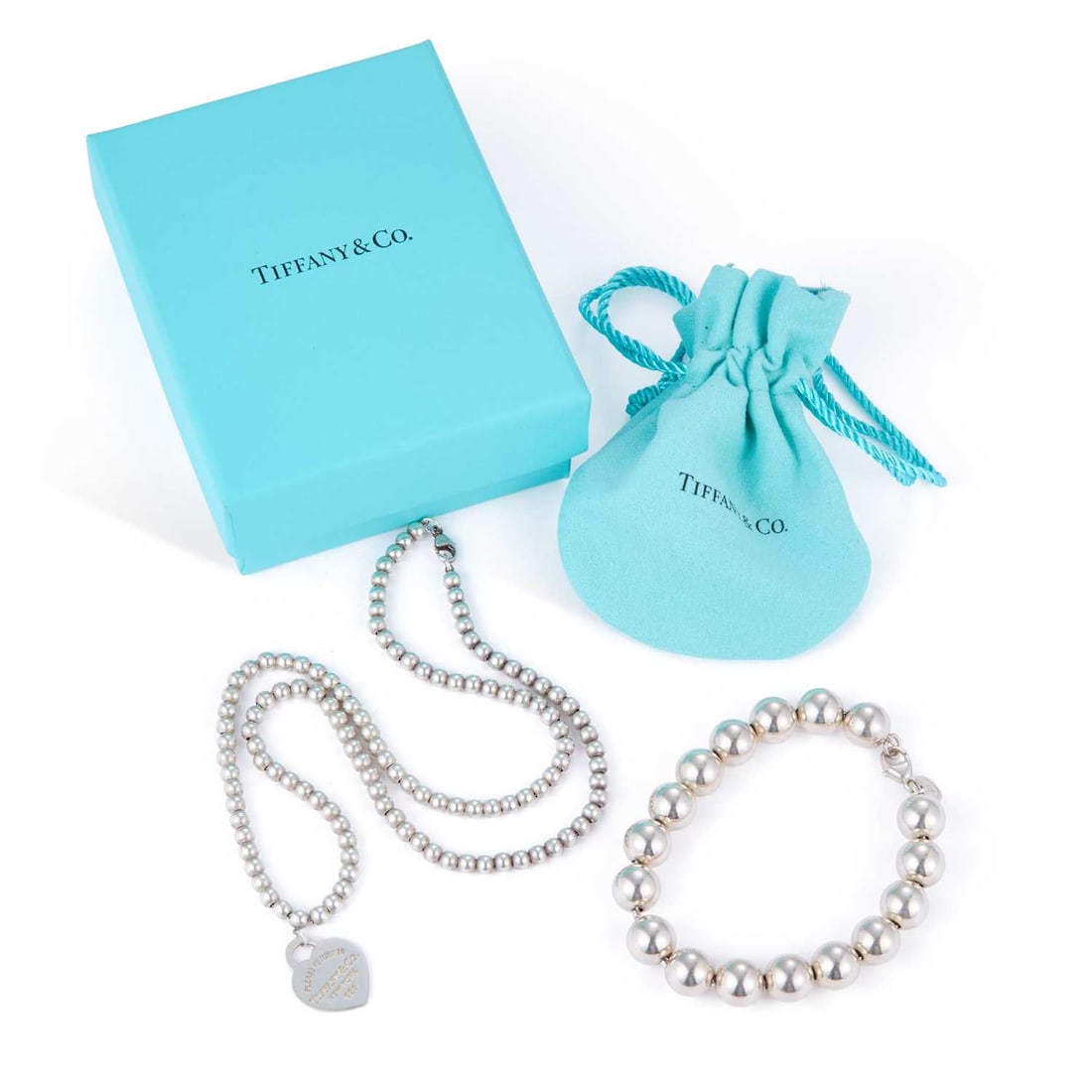 A TIFFANY & CO BEAD LINK NECKLACE AND BRACELET: A TIFFANY & CO BEAD LINK NECKLACE AND BRACELET comprising a bead link necklace with a heart-shaped 'Please Return to Tiffany & Co' tag, hallmarked, with box and pouch; and a plain ball chain brace