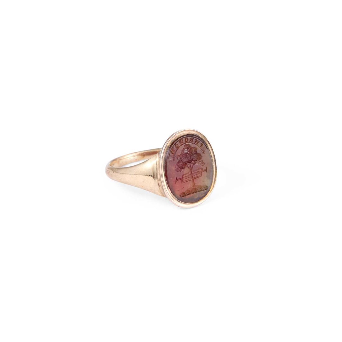 A VICTORIAN INTAGLIO SIGNET RING: A VICTORIAN INTAGLIO SIGNET RING the agate engraved with a tree being sawn and inscribed 'Through', unmarked. Ring size R1/2, head 1.7cm long, 5.3 grams Light general wear. XRF tests as 9 carat gold