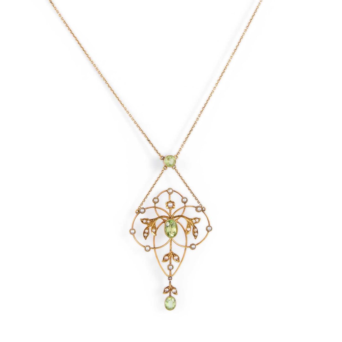 AN EDWARDIAN PERIDOT AND SEED PEARL PENDANT NECKLACE: AN EDWARDIAN PERIDOT AND SEED PEARL PENDANT NECKLACE an oval-cut peridot within a seed pearl-set scroll frame, suspending a peridot drop and tied to a peridot link to a fine chain, stamped '9CT'.