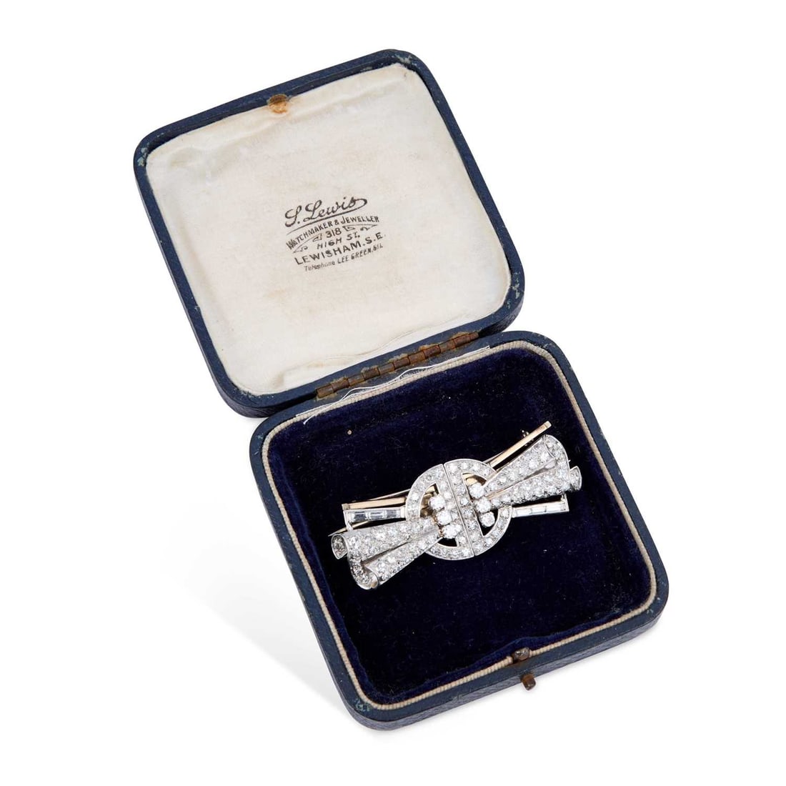A DIAMOND LAPEL CLIP BROOCH: A DIAMOND LAPEL CLIP BROOCH of buckle and scroll form and set throughout with round-cut and baguette-cut diamonds, unmarked. Estimated total diamond weight 3.50 carat, 5.7cm long, 18.7 grams Good cond