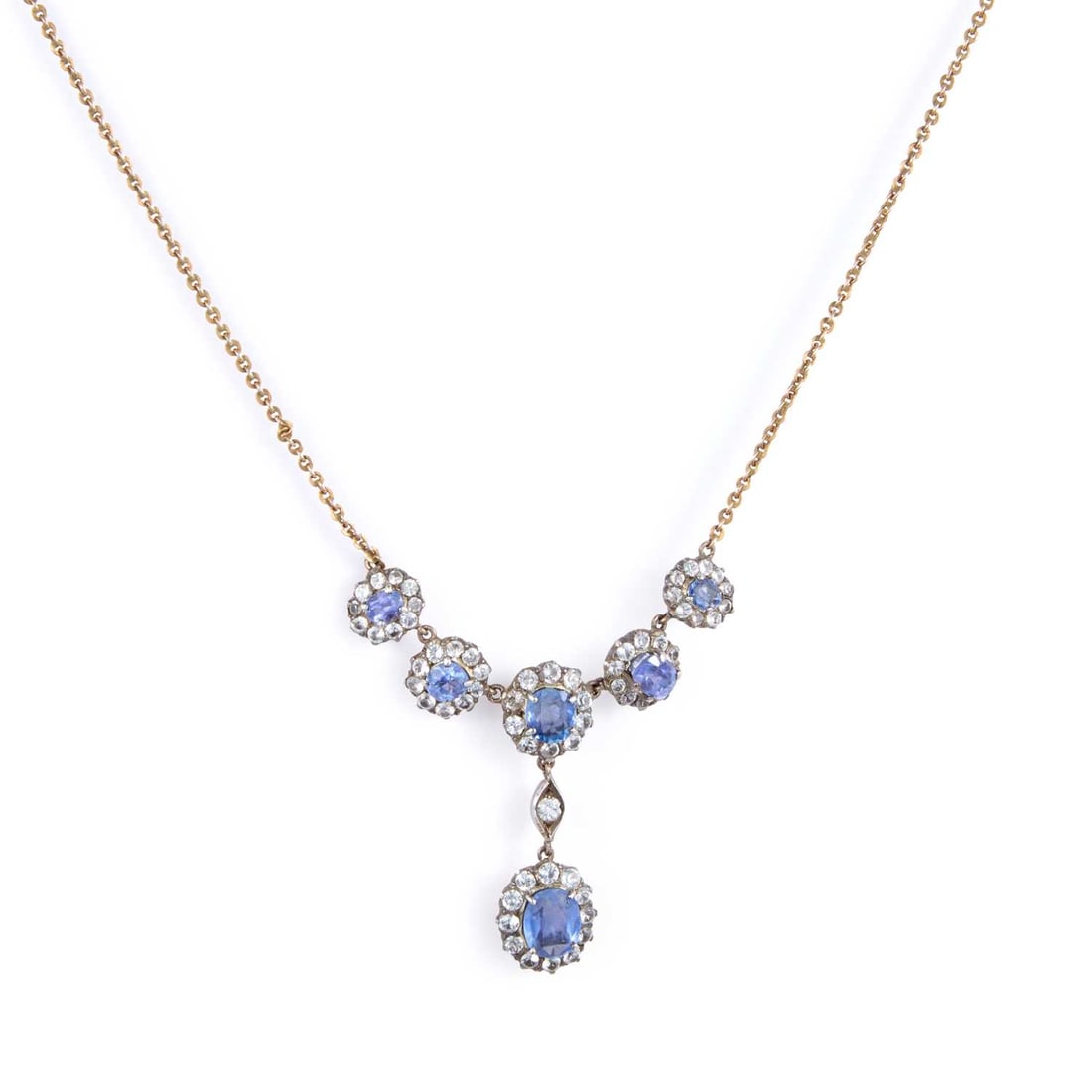 A SAPPHIRE CLUSTER PENDANT NECKLACE: A SAPPHIRE CLUSTER PENDANT NECKLACE a group of cushion-cut sapphires within borders of round-cut white stones, to a later fine chain, unmarked. Drop length 3.5cm, chain length 40cm long, 7.6 grams