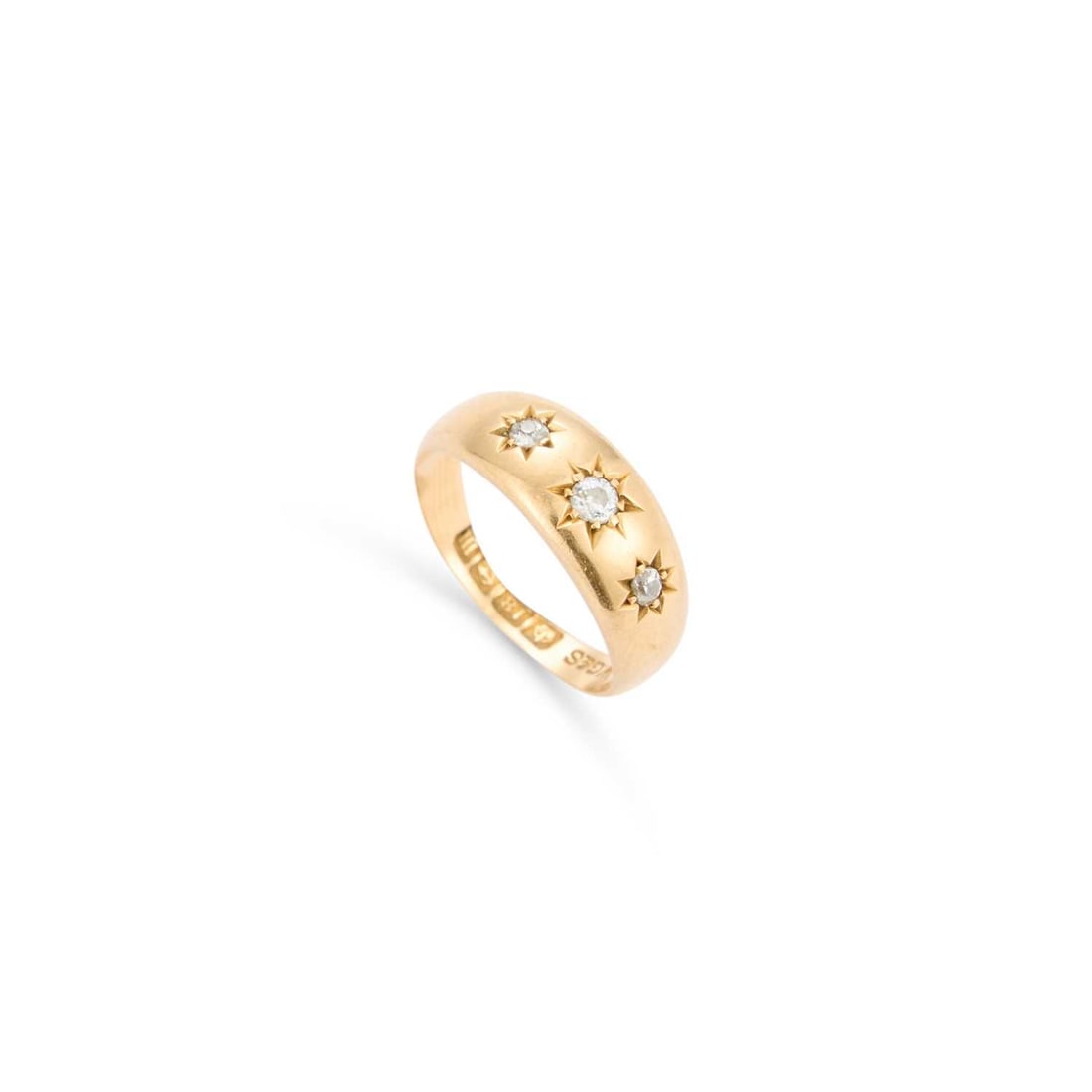 AN 18 CARAT GOLD DIAMOND THREE STONE RING: AN 18 CARAT GOLD DIAMOND THREE STONE RING graduated old-cut diamonds in star settings, to a tapering band, hallmarked 1911. Estimated total diamond weight 0.20 carat, ring size M, 4.6 grams Slight