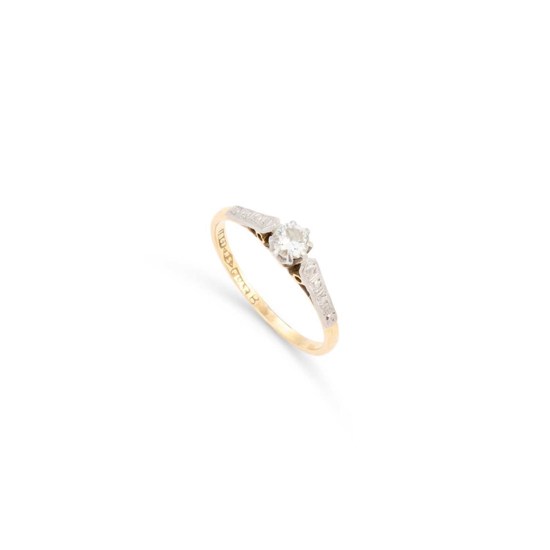 A SOLITAIRE DIAMOND RING: A SOLITAIRE DIAMOND RING a round brilliant-cut diamond to engraved shoulders, stamped '18CT PLAT'. Estimated diamond weight 0.25 carat, ring size L1/2, 1.9 grams Shank a little thin. Estimated