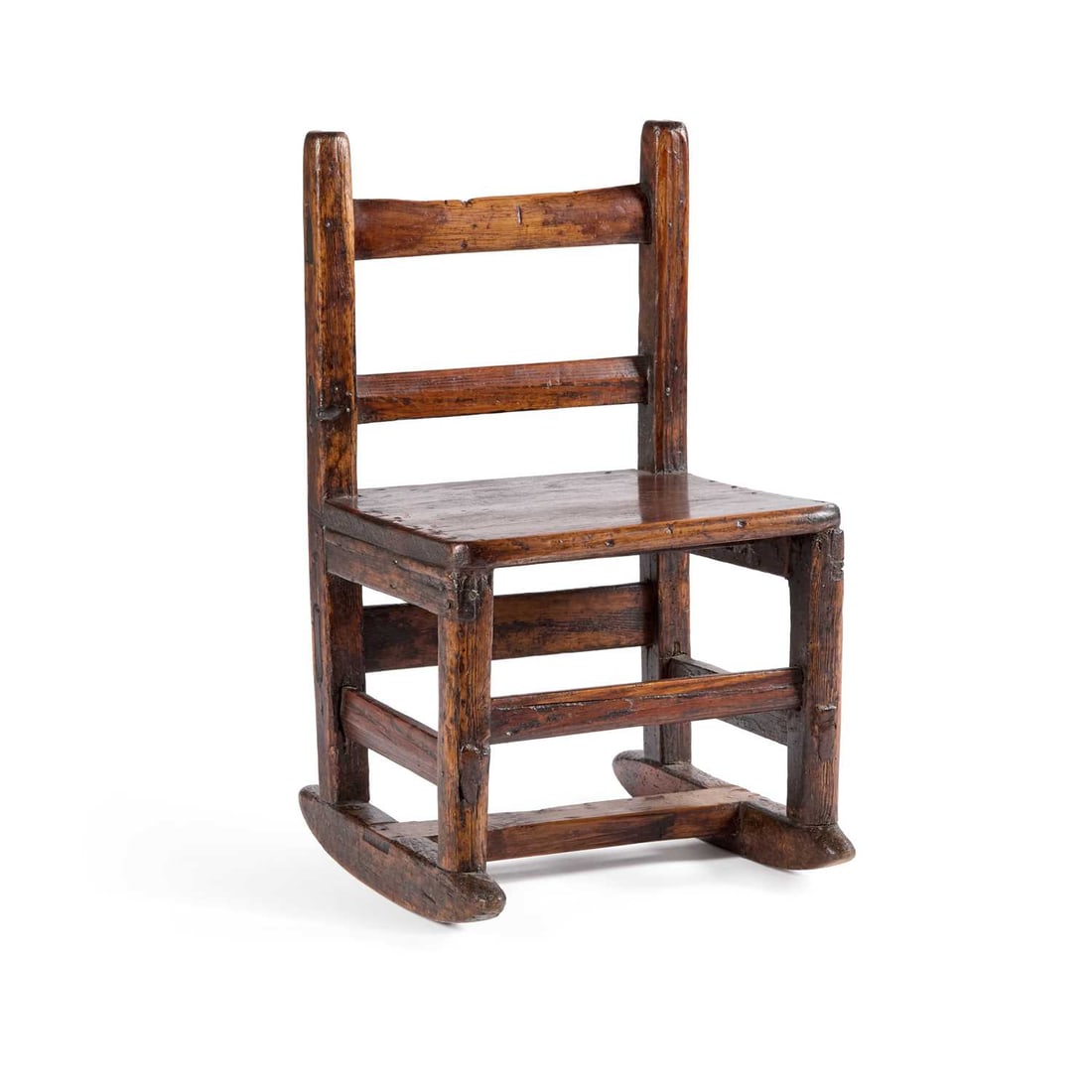A RUSTIC CHILD'S ROCKING CHAIR: A RUSTIC CHILD'S ROCKING CHAIR with a boarded seat. Height of back 58cm