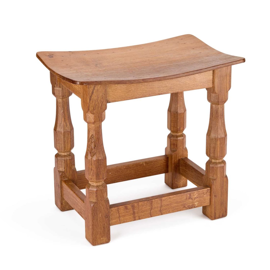 ROBERT THOMPSON OF KILBURN A MOUSEMAN OAK DISH TOP STOOL: ROBERT THOMPSON OF KILBURN A MOUSEMAN OAK DISH TOP STOOL the rectangular adzed and nailed top with rounded corners, on four octagonal legs joined by stretchers, with carved mouse signature. 38.5cm hig