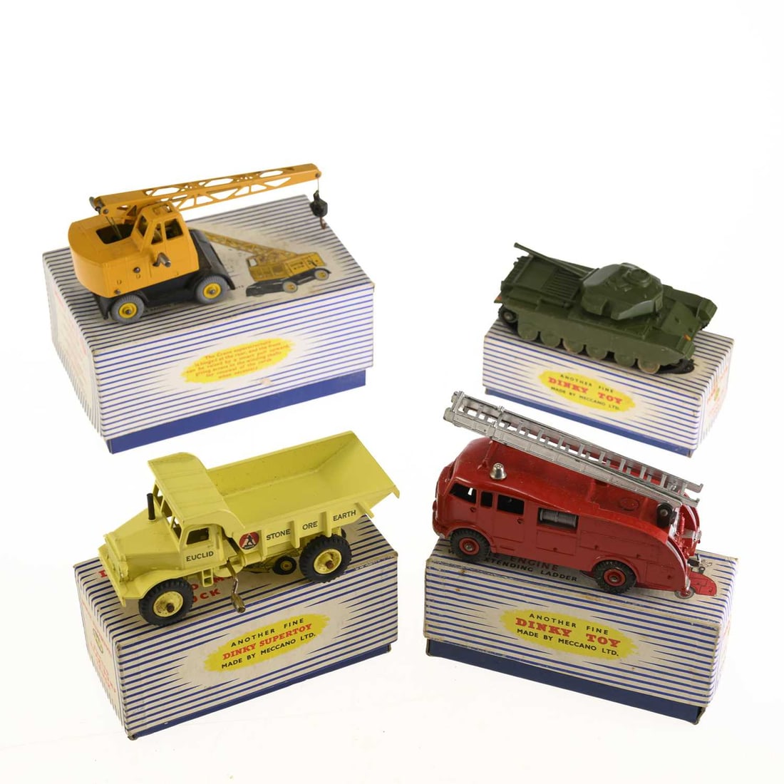 FOUR DINKY SUPERTOYS DIECAST MODELS: FOUR DINKY SUPERTOYS DIECAST MODELS comprising a Euclid Rear Dump Truck, no. 965, boxed; a Coles Mobile Crane, no. 971, boxed; a Fire Engine with extending ladder, no. 555, boxed; and a Centurion Tank