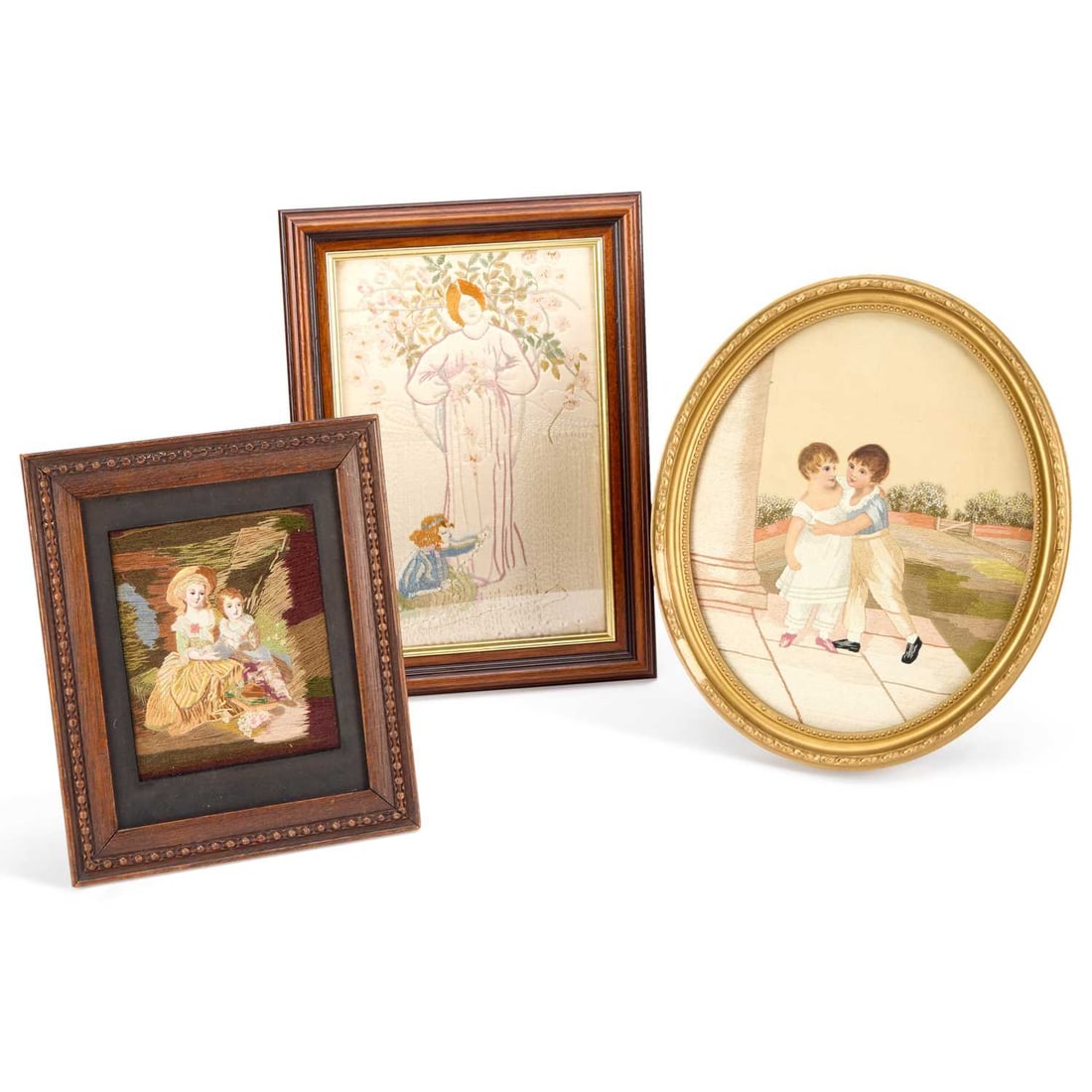 THREE SILKWORK PICTURES CIRCA 1900: THREE SILKWORK PICTURES CIRCA 1900 comprising the first of a mother and child in Art Nouveau style, framed; the two other silkworks of brothers and sisters in period costume. (3) First 34cm by 25cm