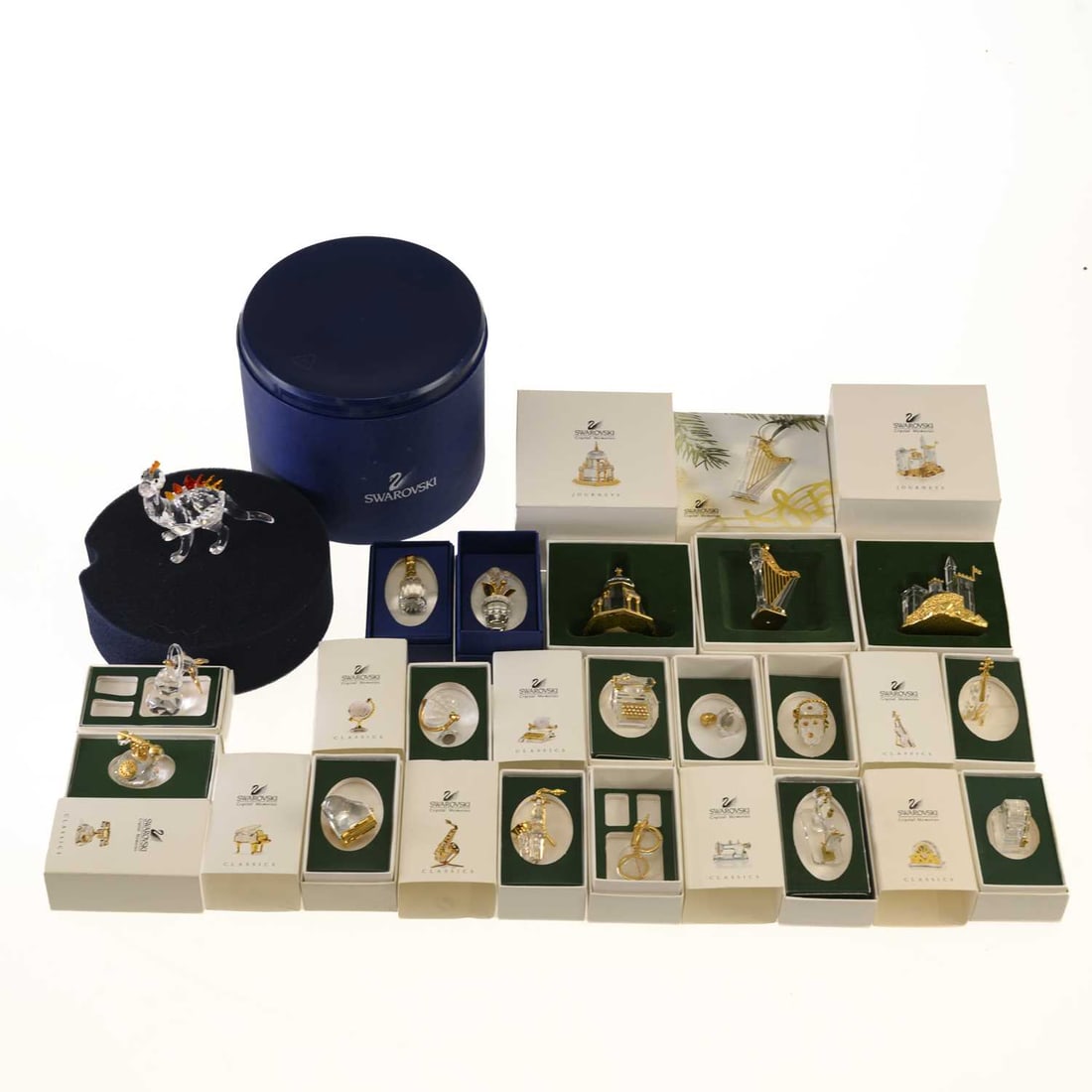 A GROUP OF SWAROVSKI CRYSTAL FIGURES: A GROUP OF SWAROVSKI CRYSTAL FIGURES including a 'Dino the Dinosaur', model no. 268204, boxed; a Journeys Crystal Memories 'Castle Gold', model no. 243449, boxed; a Journeys Crystal Memories