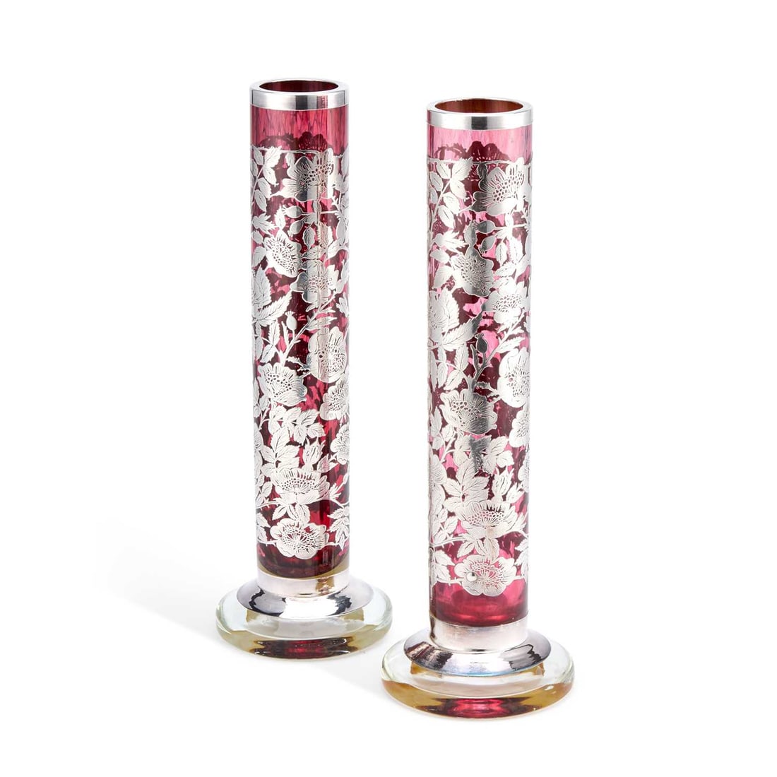 A PAIR OF BOHEMIAN SILVER OVERLAID RUBY GLASS VASES CIRCA 1920: A PAIR OF BOHEMIAN SILVER OVERLAID RUBY GLASS VASES CIRCA 1920 set upon circular pedestal feet, overlaid and engraved with flowering plants. (2) 40cm high