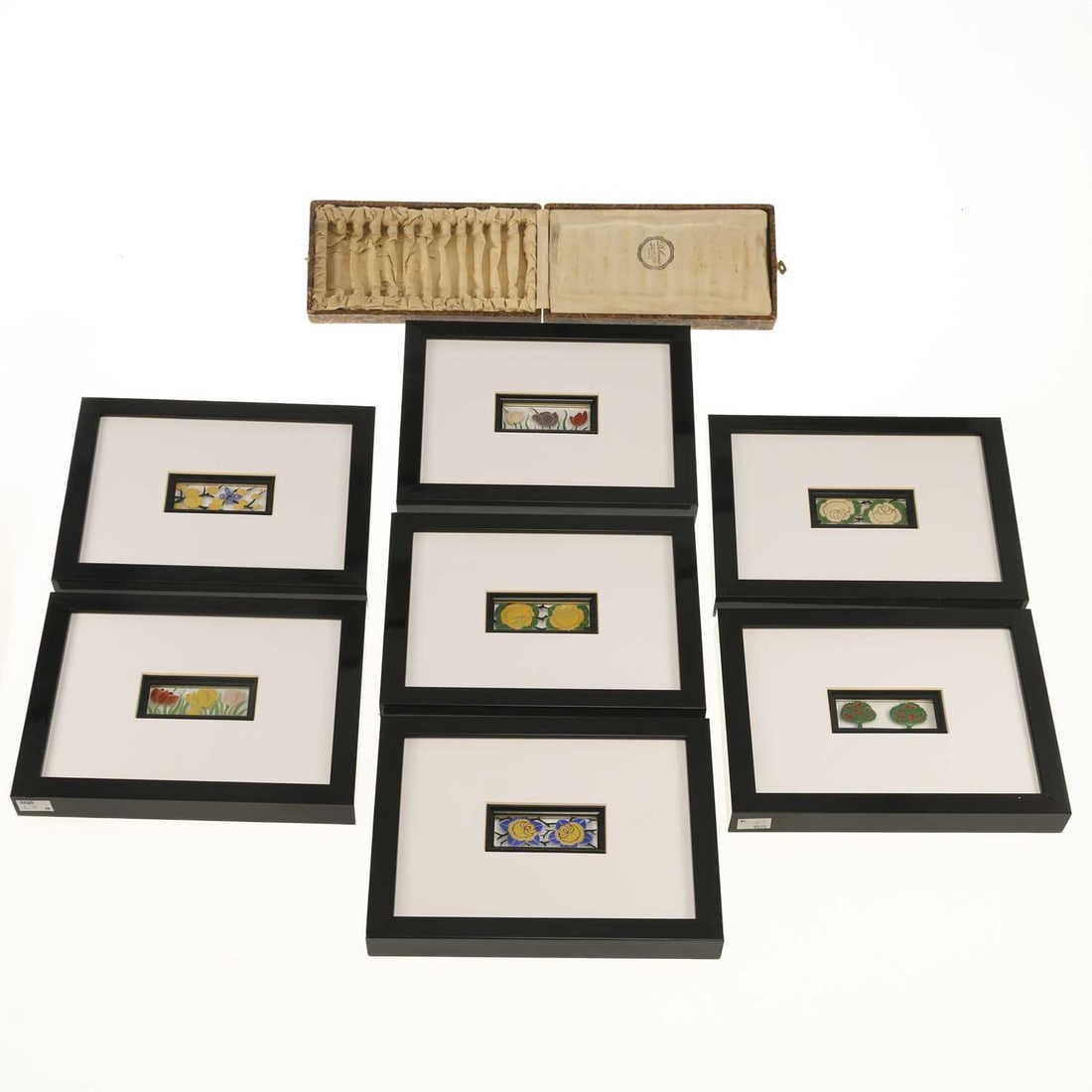 V A SET OF SEVEN FRENCH ENAMELLED ART NOUVEAU GLASS PANELS BY DELVAUX: V A SET OF SEVEN FRENCH ENAMELLED ART NOUVEAU GLASS PANELS BY DELVAUX each decorate with a foliate pattern in polychrome enamels, signed to lower edges, housed within modern frames, together with