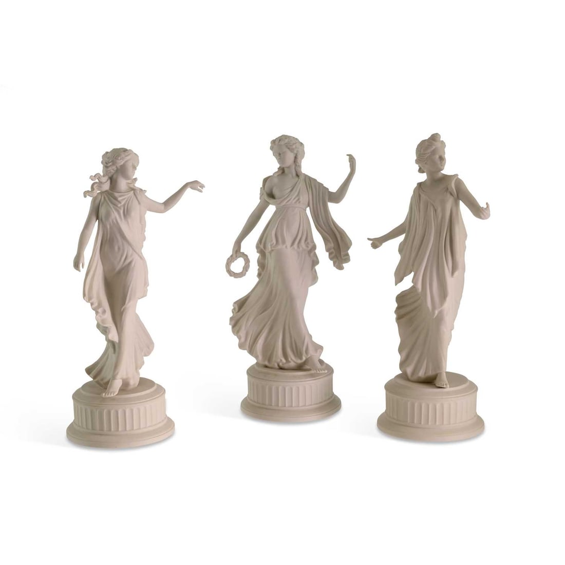 A GROUP OF THREE WEDGWOOD WHITE BISCUIT FIGURES FROM THE ‘DANCING HOURS’ SERIES: A GROUP OF THREE WEDGWOOD WHITE BISCUIT FIGURES FROM THE ‘DANCING HOURS’ SERIES each modelled as a classically draped maiden upon a circular fluted pedestal base, one holding a wreath. (3) Tallest