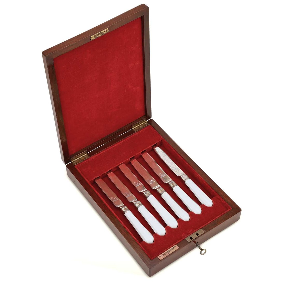 A RARE SET OF SIX CHELSEA KNIVES CIRCA 1755: A RARE SET OF SIX CHELSEA KNIVES CIRCA 1755 the straight faceted shafts left in the white, two showing red anchor marks, the silver blades by Moses Brent, London 1805, engraved with the crest of a sta