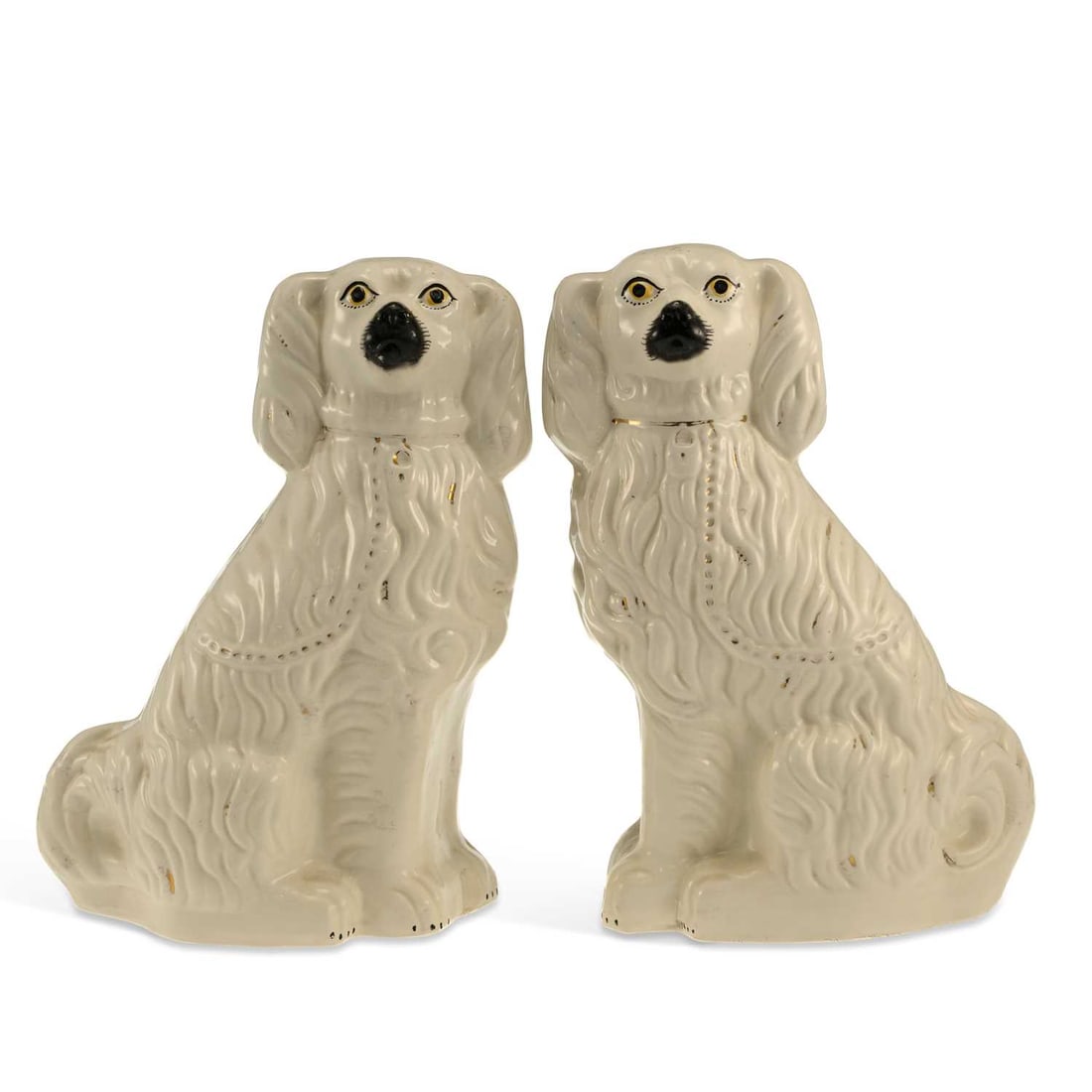 A PAIR OF STAFFORDSHIRE POTTERY SPANIELS CIRCA 1870: A PAIR OF STAFFORDSHIRE POTTERY SPANIELS CIRCA 1870 the white glazed seated Spaniels with gilt highlights. (2) 38cm high