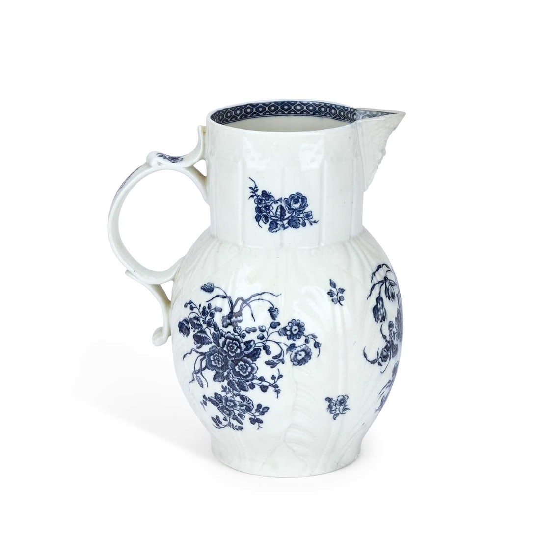 A WORCESTER CABBAGE LEAF MOULDED MASK JUG CIRCA 1780: A WORCESTER CABBAGE LEAF MOULDED MASK JUG CIRCA 1780 printed in underglaze blue with flower sprays. 24cm high Restoration to the mask and possibly to the base.