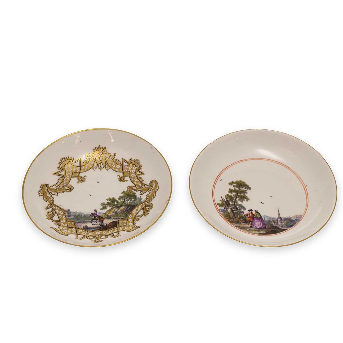 TWO MEISSEN PORCELAIN SAUCERS CIRCA 1740: TWO MEISSEN PORCELAIN SAUCERS CIRCA 1740 comprising the first saucer painted with figures crossing a bridge, within an elaborate gilt strapwork panel, the reverse with sprigs of flowers; the other
