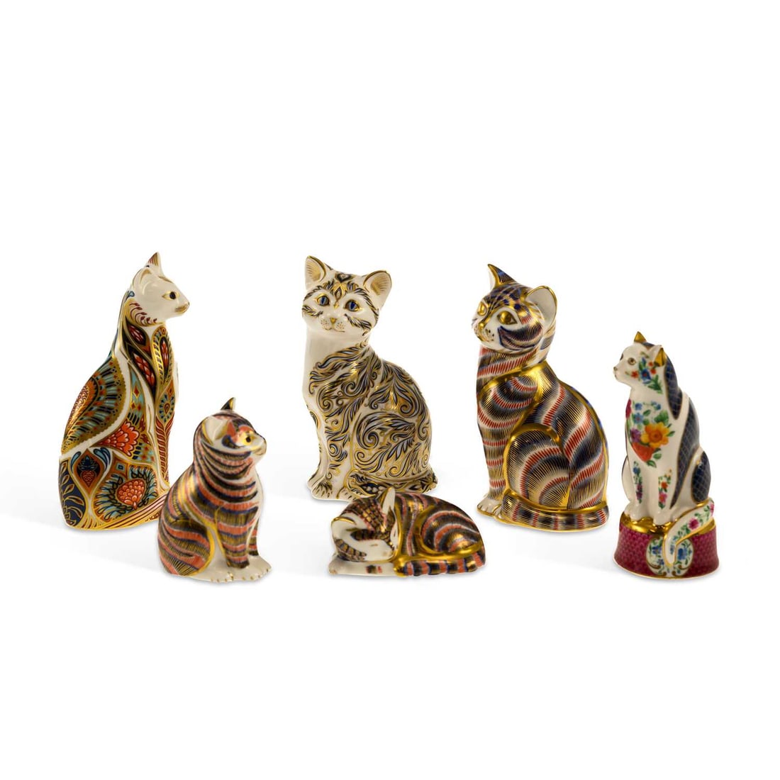 A GROUP OF ROYAL CROWN DERBY CAT PAPERWEIGHTS: A GROUP OF ROYAL CROWN DERBY CAT PAPERWEIGHTS comprising each decorated in variants of the Imari pattern, printed factory marks; together with a Royal Worcester cat seated on a cushion, puce printed f