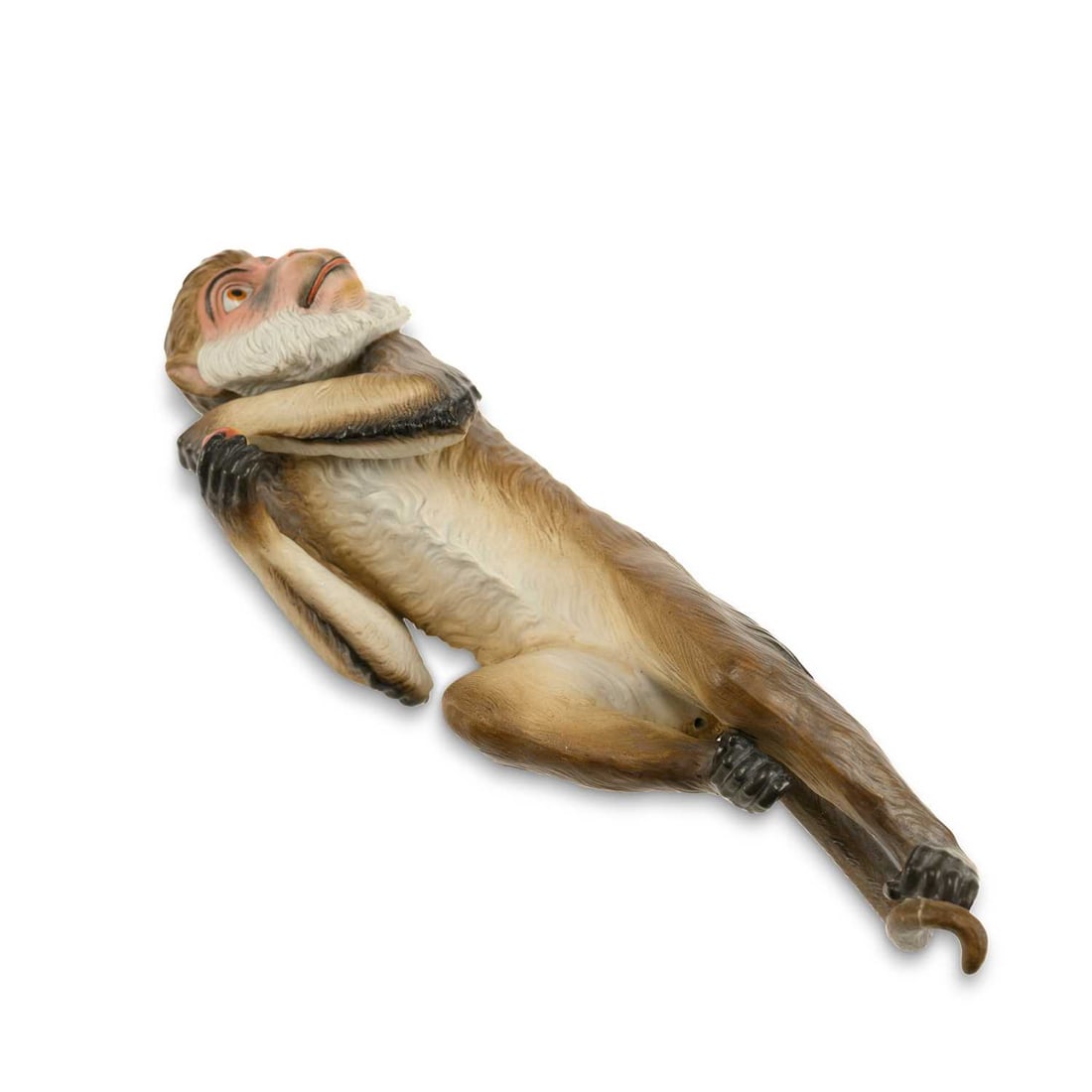 A GERMAN BISQUE MONKEY CIRCA 1890: A GERMAN BISQUE MONKEY CIRCA 1890 well modelled as a monkey holding an apple, climbing an imaginary vine. 29.5cm long
