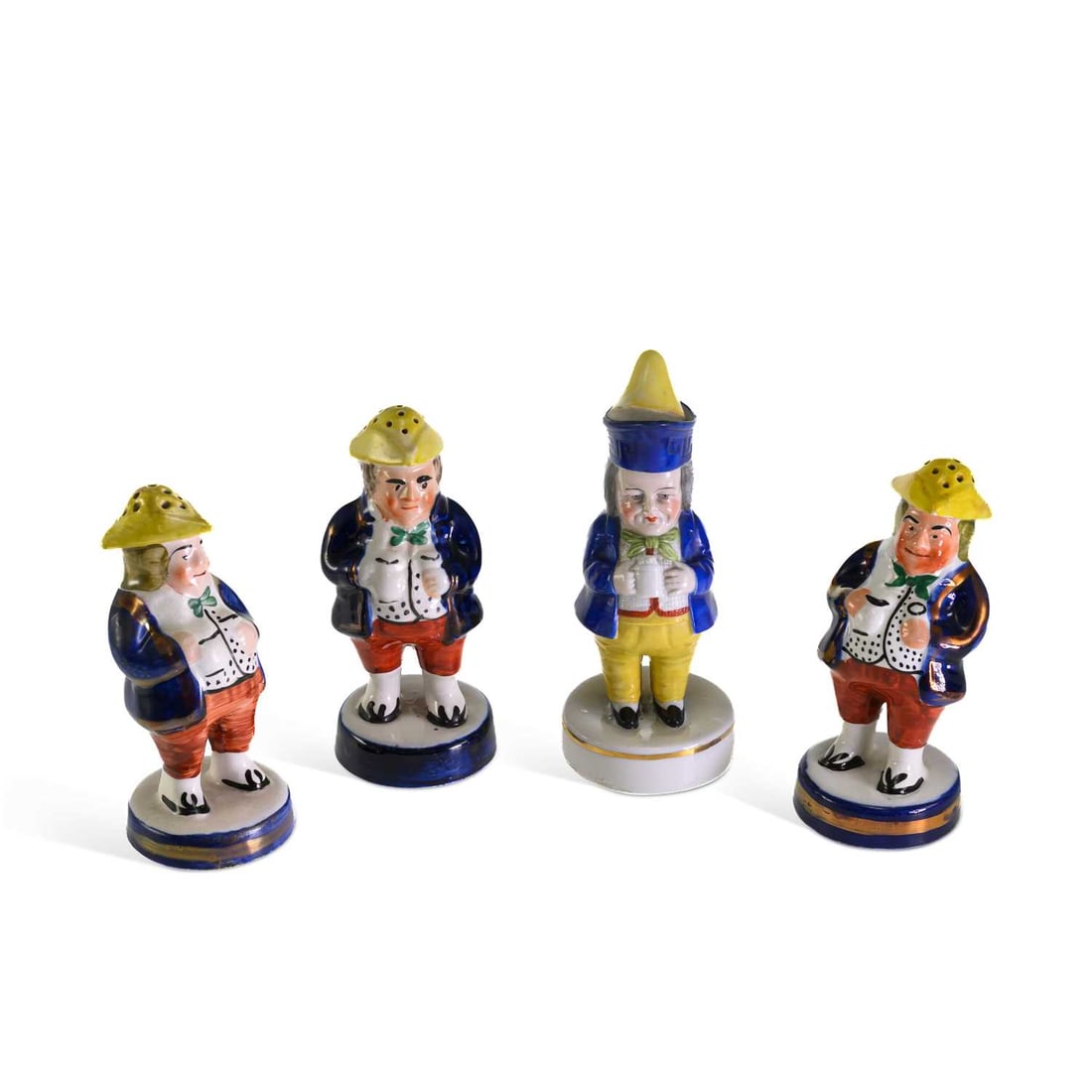 THREE VICTORIAN STAFFORDSHIRE POTTERY FIGURAL SALT AND PEPPER POTS: THREE VICTORIAN STAFFORDSHIRE POTTERY FIGURAL SALT AND PEPPER POTS the Staffordshire examples modelled as portly gentlemen in eighteenth-century dress, each brightly enamelled with gilt highlights;