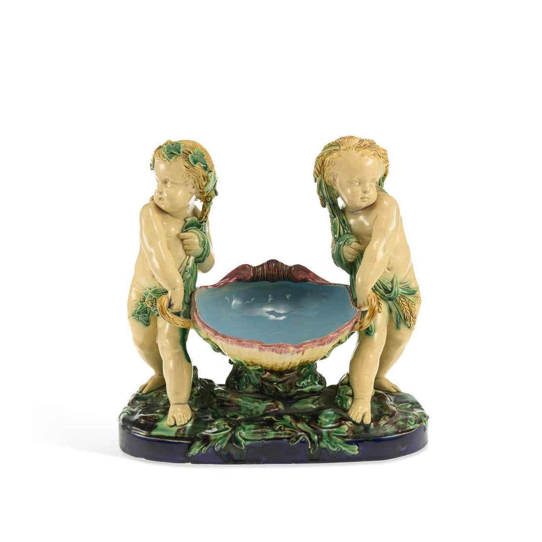 A MINTON MAJOLICA CHERUBS BASKET DATED 1868: A MINTON MAJOLICA CHERUBS BASKET DATED 1868 modelled as two cherubs carrying a large shell, impressed factory marks and date code for 1868. 28.5cm wide