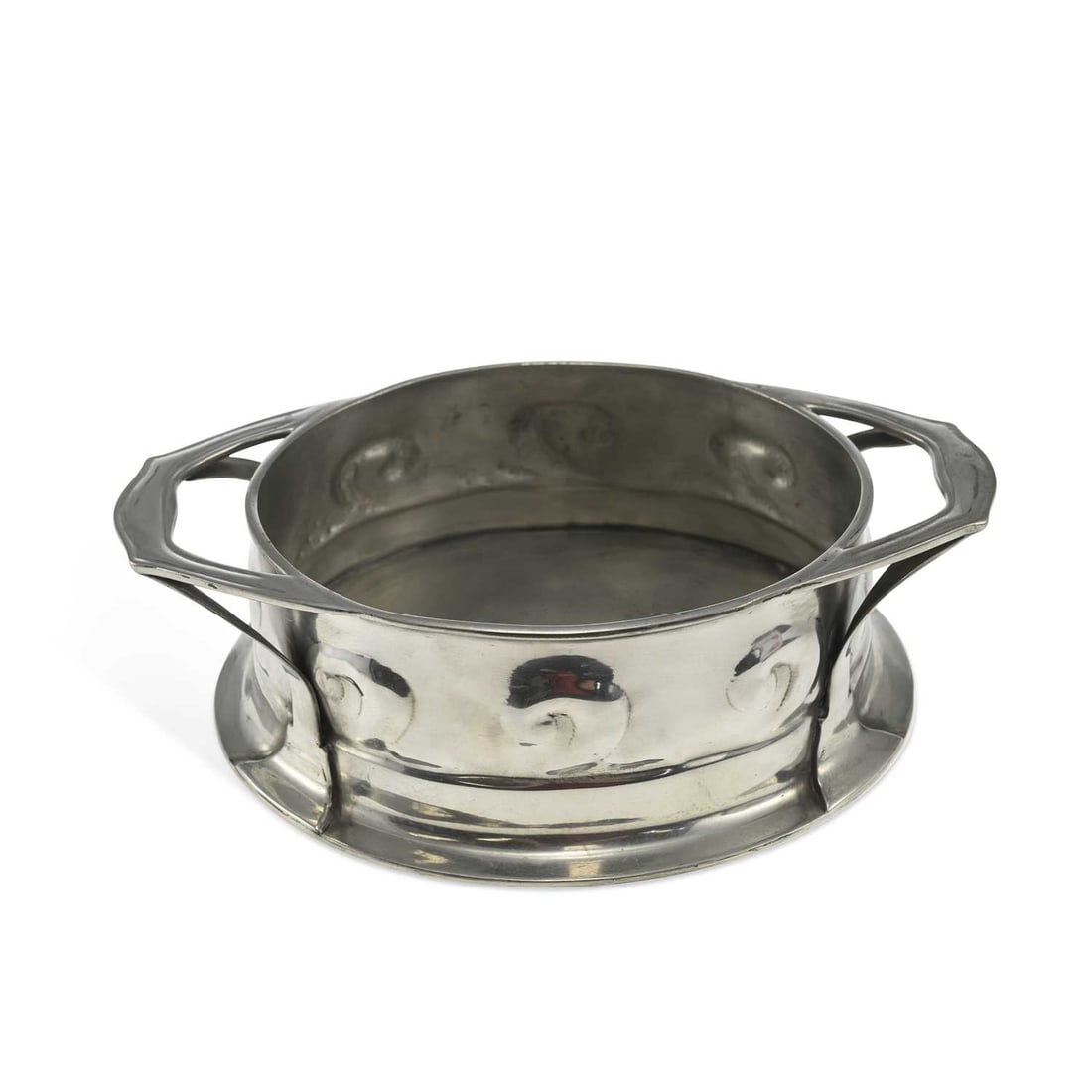 OLIVER BAKER FOR LIBERTY & CO A LARGE TUDRIC PEWTER TWO-HANDLED JARDINIÈRE: OLIVER BAKER FOR LIBERTY & CO A LARGE TUDRIC PEWTER TWO-HANDLED JARDINIÈRE no. 0191, oval, the body with swirl decoration to the sides, on a spreading oval foot, stamped marks. 32.5cm over handles