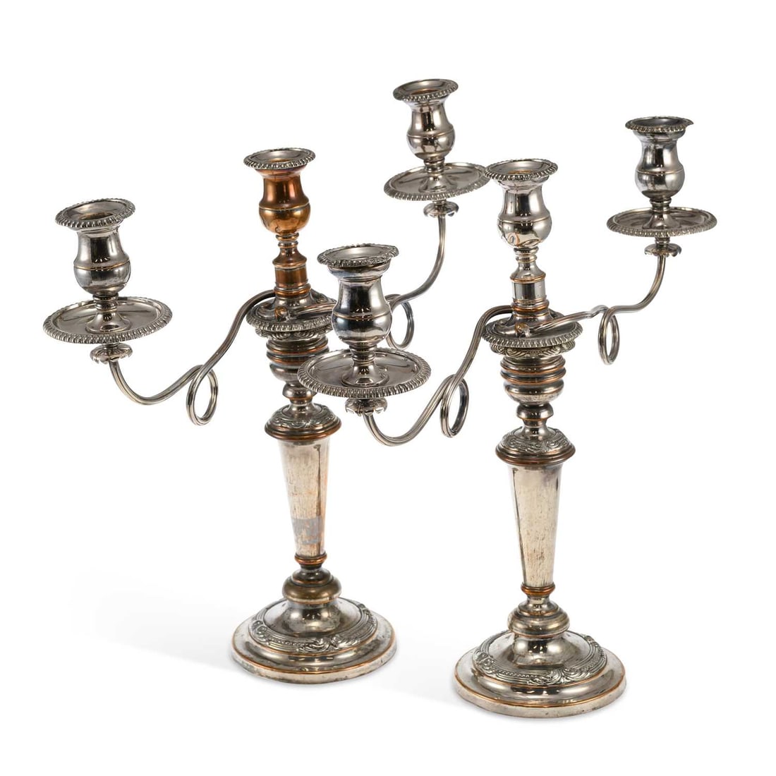 A PAIR OF OLD SHEFFIELD PLATE THREE-LIGHT CANDELABRA: A PAIR OF OLD SHEFFIELD PLATE THREE-LIGHT CANDELABRA each tapering knopped column supporting an associated detachable reeded and scrolling two-arm superstructure from the central sconce, raised on a