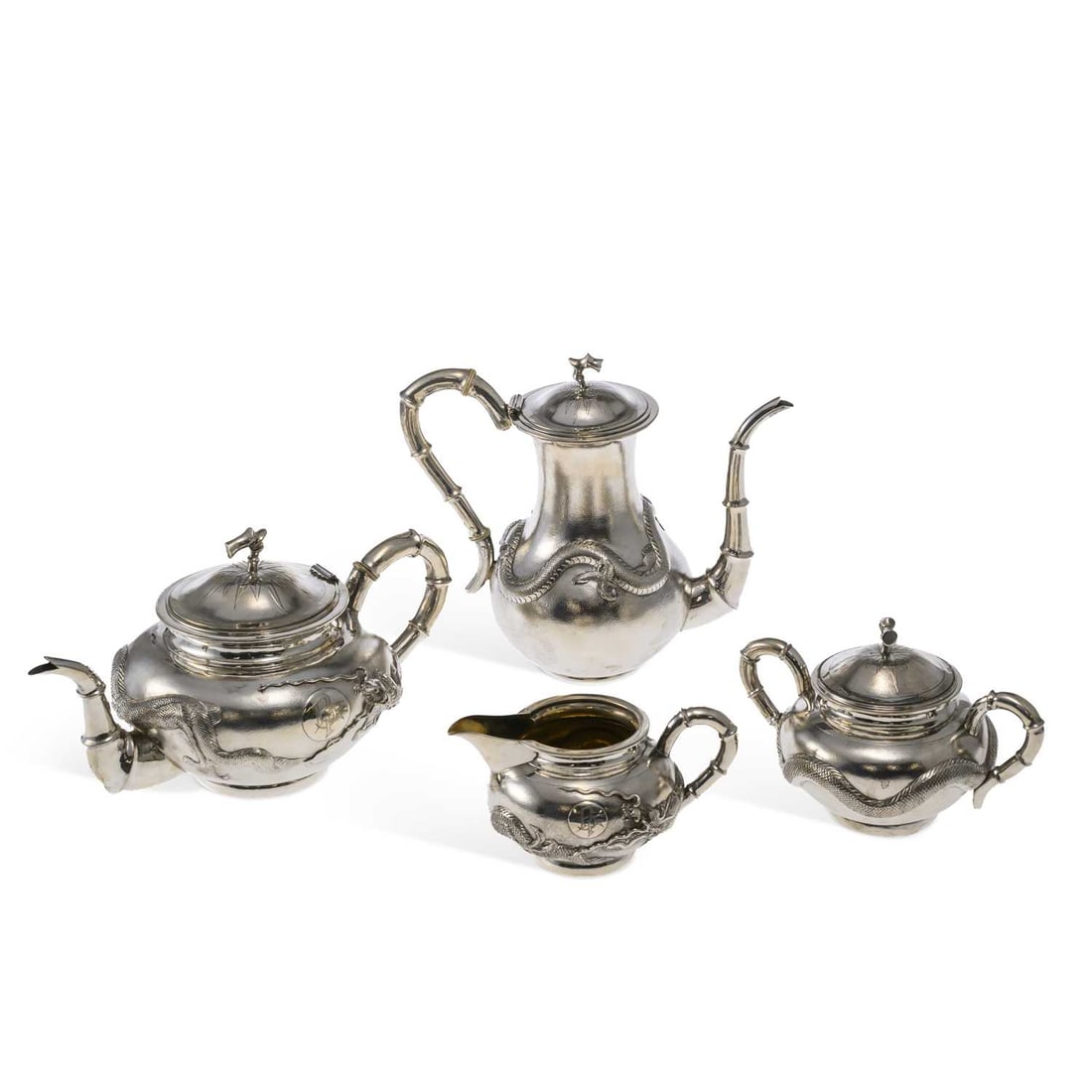 § A CHINESE EXPORT FOUR-PIECE STERLING SILVER TEA SERVICE: § A CHINESE EXPORT FOUR-PIECE STERLING SILVER TEA SERVICE possibly by China Jewellery Company (marked CJCo), 20th century, comprising a teapot, coffee pot, milk jug and two-handled sugar bowl, each o