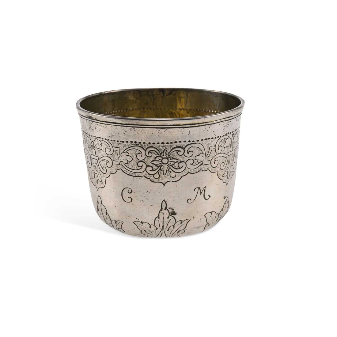 A RUSSIAN SILVER VODKA BEAKER OR CHARKA: A RUSSIAN SILVER VODKA BEAKER OR CHARKA mid-18th century, variously marked to the base, of tapering cylindrical form with engraved foliate decoration, gilt interior. 5.8cm high, 2.5 troy ounces
