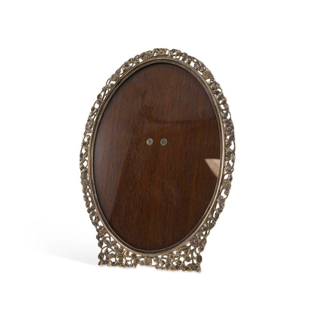 A CONTINENTAL SILVER PHOTOGRAPH FRAME: A CONTINENTAL SILVER PHOTOGRAPH FRAME of oval form, the pierced border embossed with flowerhead and berry motif, with a wooden easel back. 22cm high