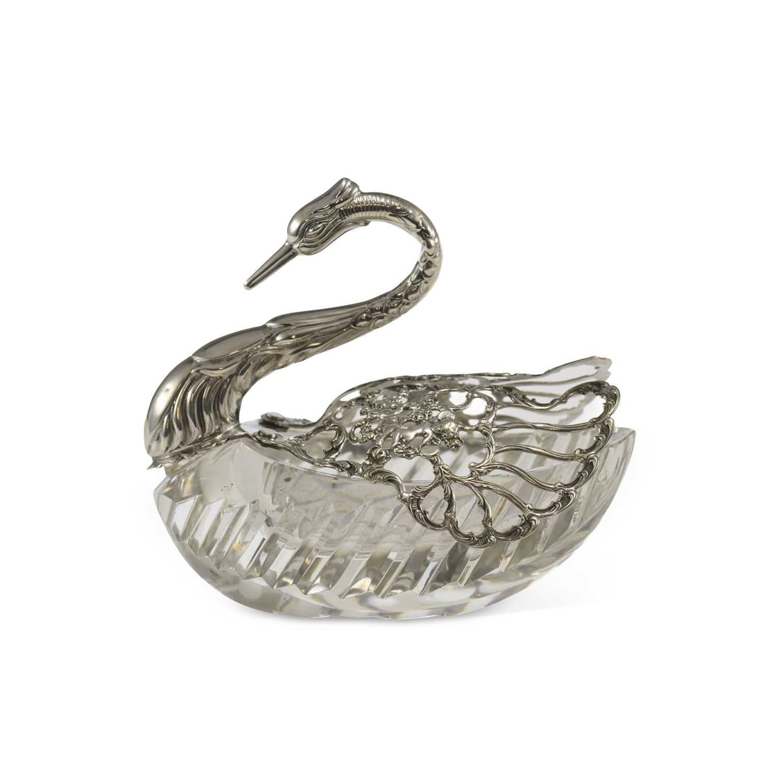 A CONTINENTIAL SILVER-MOUNTED CUT-GLASS DRESSING TABLE BOX: A CONTINENTIAL SILVER-MOUNTED CUT-GLASS DRESSING TABLE BOX bearing import marks, in the form of a swan, the pierced silver wings with putti motif. 12cm high
