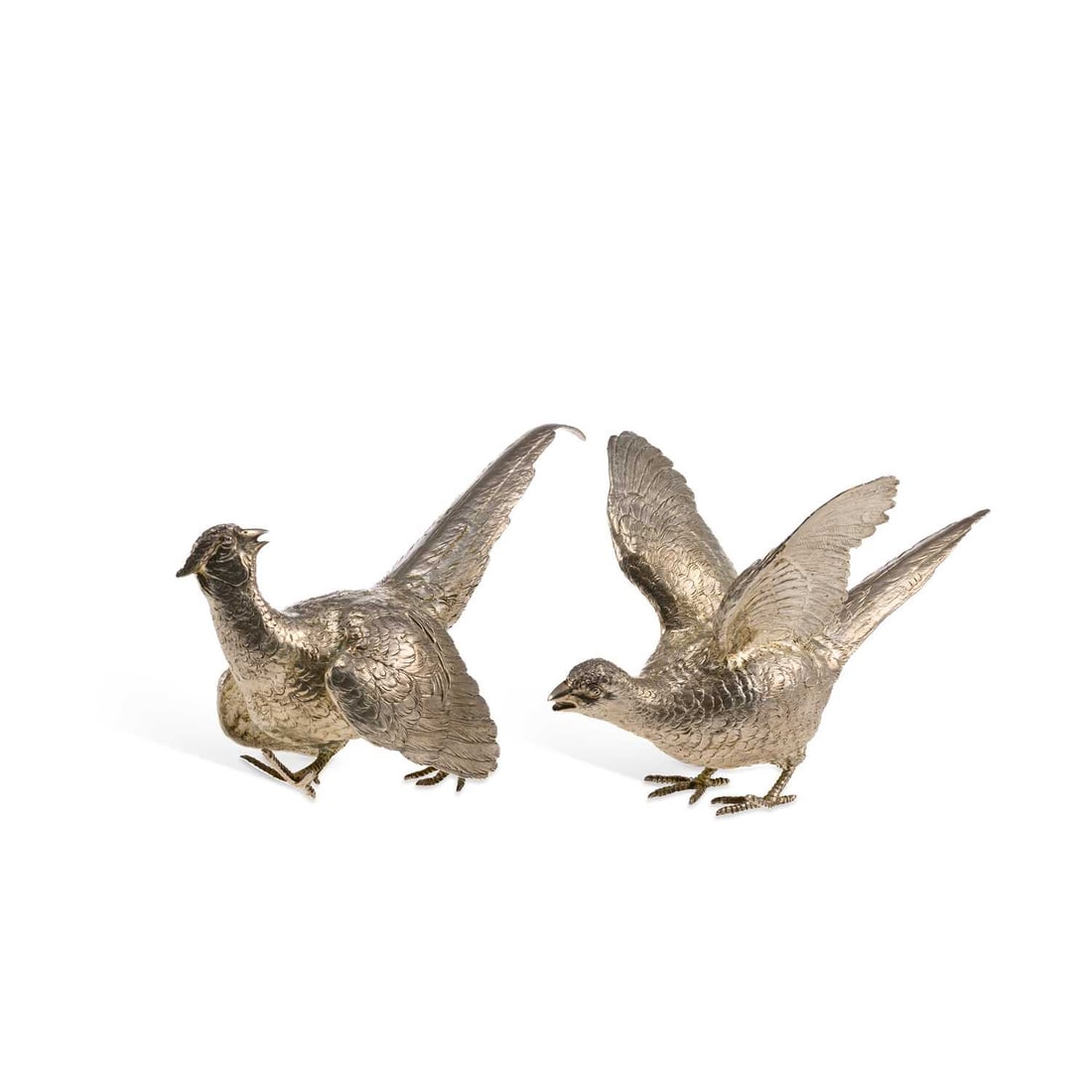 A PAIR OF ELIZABETH II SILVER MODELS OF PHEASANTS: A PAIR OF ELIZABETH II SILVER MODELS OF PHEASANTS by Edward Barnard & Sons Ltd., London 1976, the male and female birds naturalistically posed with wings and tails aloft. (2) Tallest 18cm high, 26