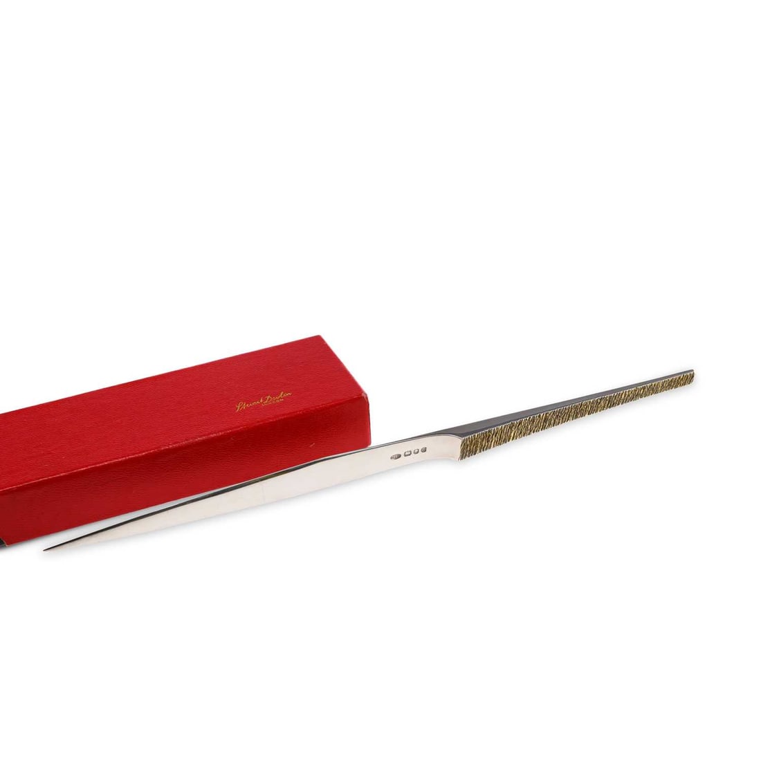 STUART DEVLIN: AN ELIZABETH II SILVER AND PARCEL-GILT PAPER KNIFE: STUART DEVLIN: AN ELIZABETH II SILVER AND PARCEL-GILT PAPER KNIFE by Stuart Devlin, London 1979, of modernist design, with a bark-textured handle and tapering blade, with manufacturer's card box. 30.5