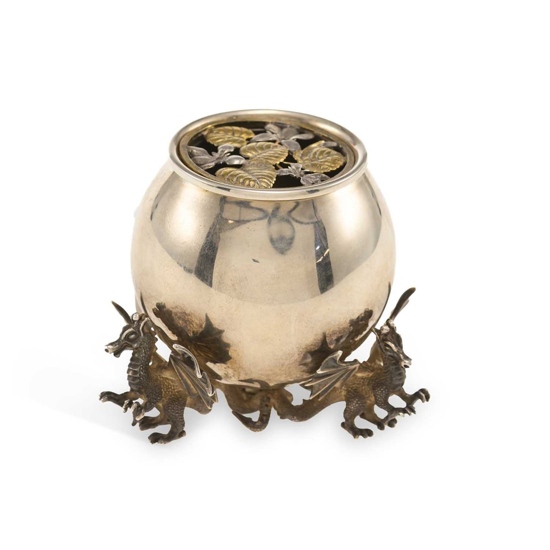 AN ELIZABETH II NOVELTY SILVER POTPOURRI HOLDER: AN ELIZABETH II NOVELTY SILVER POTPOURRI HOLDER by Peter Nicholas & Co Ltd., London 1994, of cauldron form with a foliate pierced parcel gilt cover, the three feet cast as winged dragons. 6.5cm hi