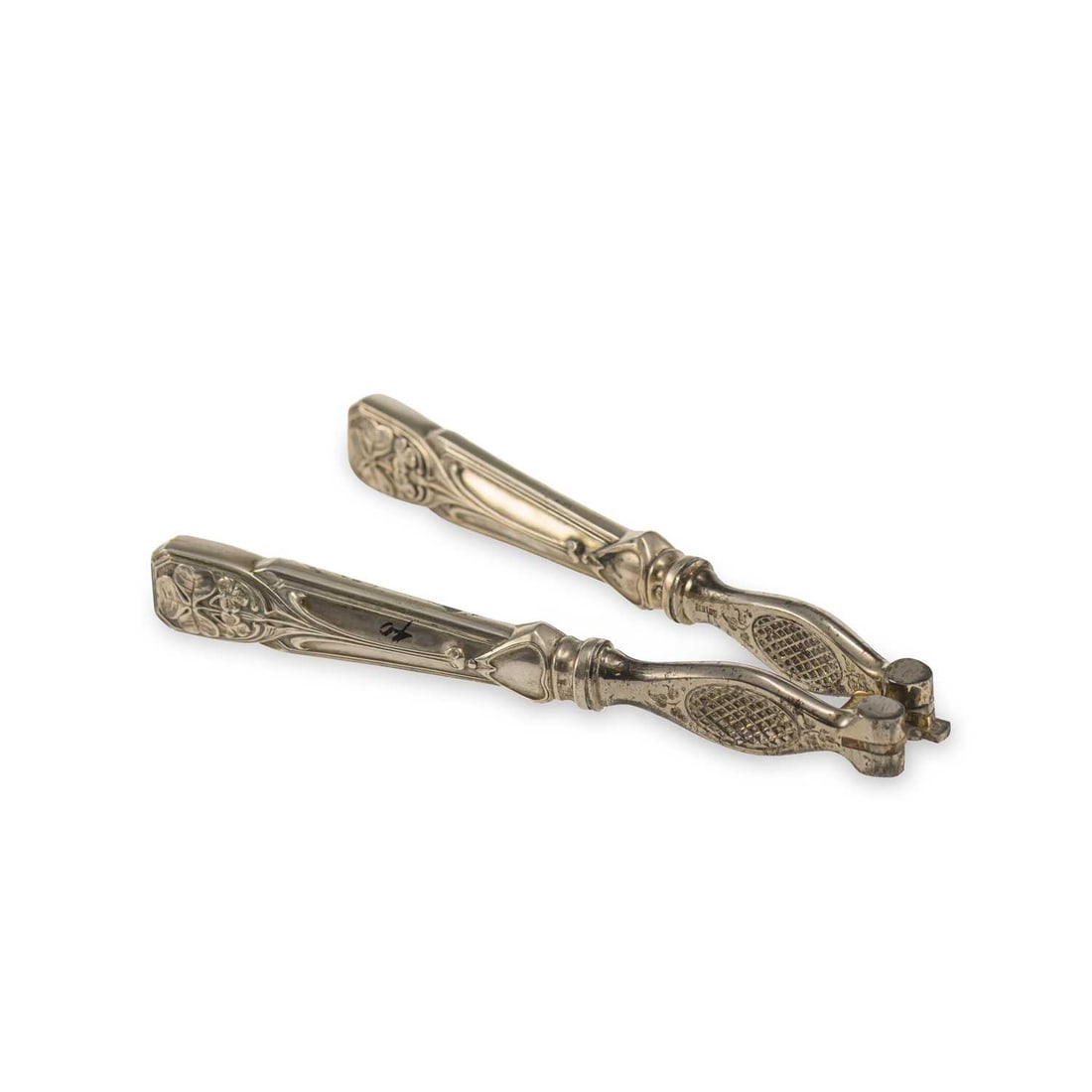A PAIR OF PORTUGUESE ART NOUVEAU SILVER HANDLED NUT CRACKERS: A PAIR OF PORTUGUESE ART NOUVEAU SILVER HANDLED NUT CRACKERS Lisbon, late 19th/ early 20th Century, cracker stamped Acier (French steel), with terminals cast as clover. 15.5cm high